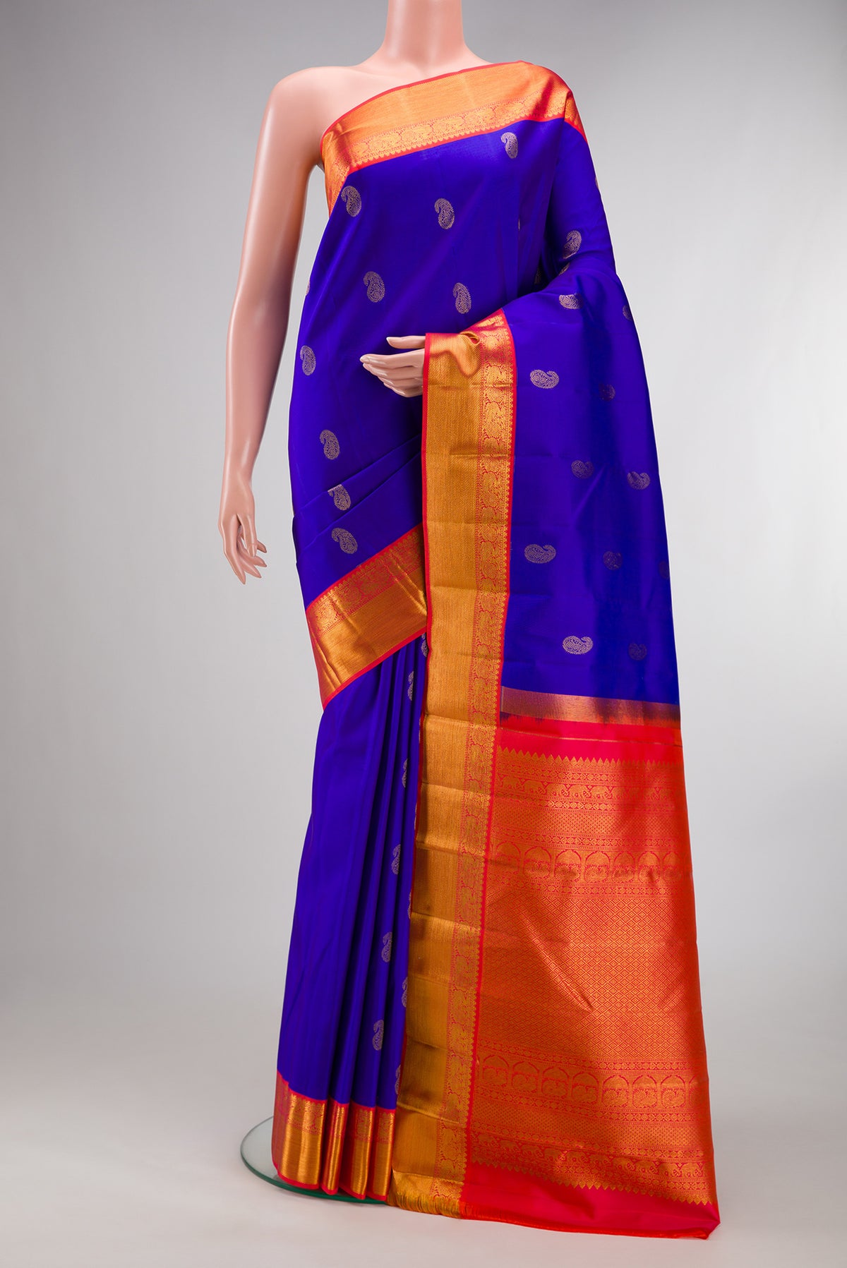 Pure Silk Royal Blue Kanjivaram Saree with Zari Butta on the body and Zari Border.  displayed on a mannequin