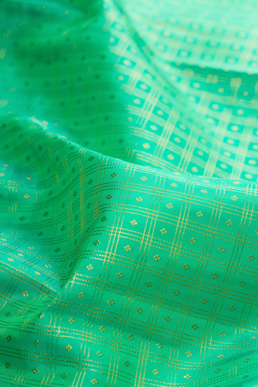 Close up of Pure Silk Sea Green Kanjivaram Saree with Checked design on the body and Zari Border.  displaying folds
