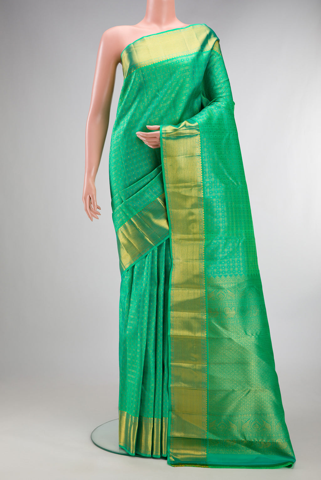 Pure Silk Sea Green Kanjivaram Saree with Checked design on the body and Zari Border.  displayed on a mannequin