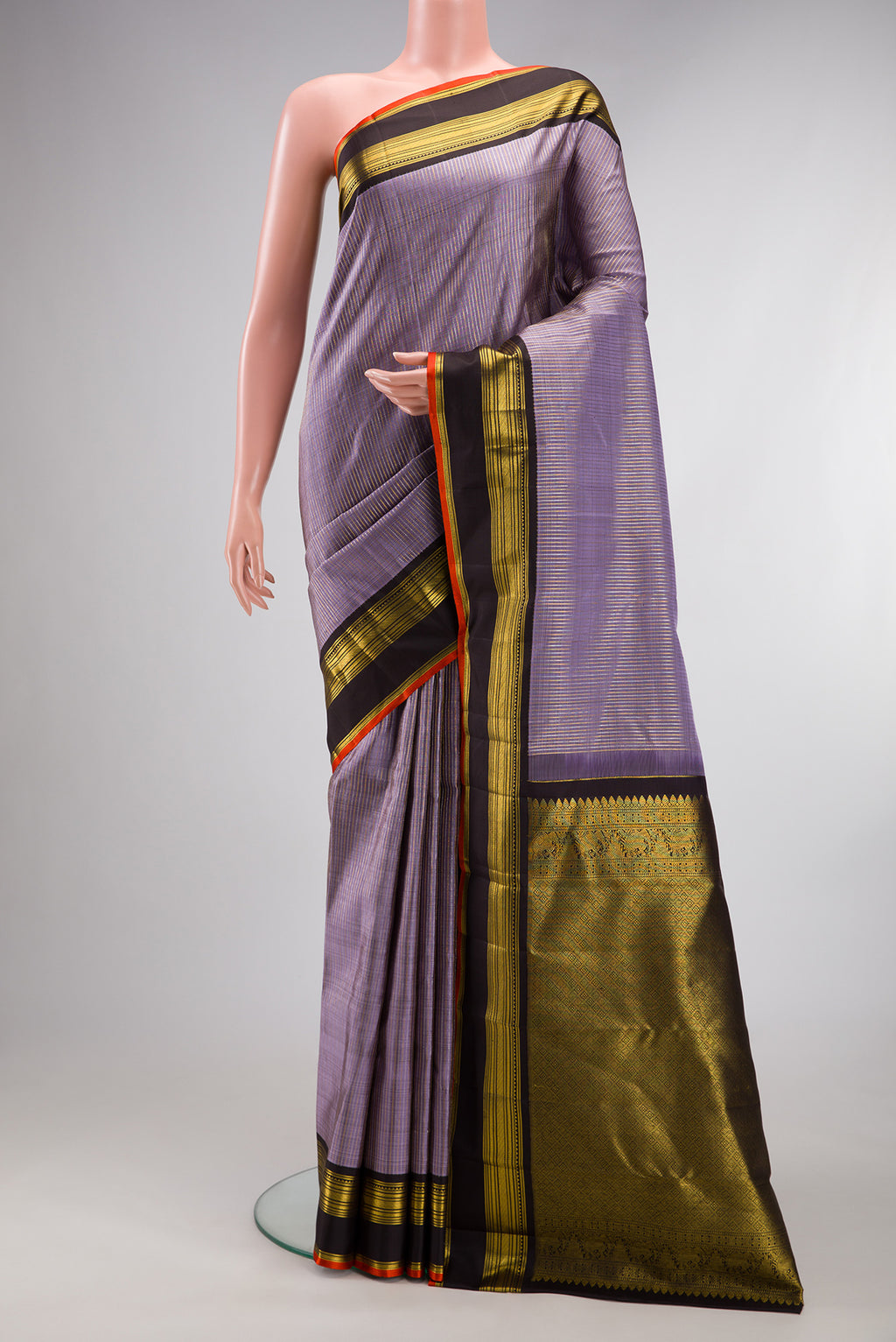 Pure Silk Lavender Kanjivaram Saree with Stripes on the body and Zari Border.  displayed on a mannequin