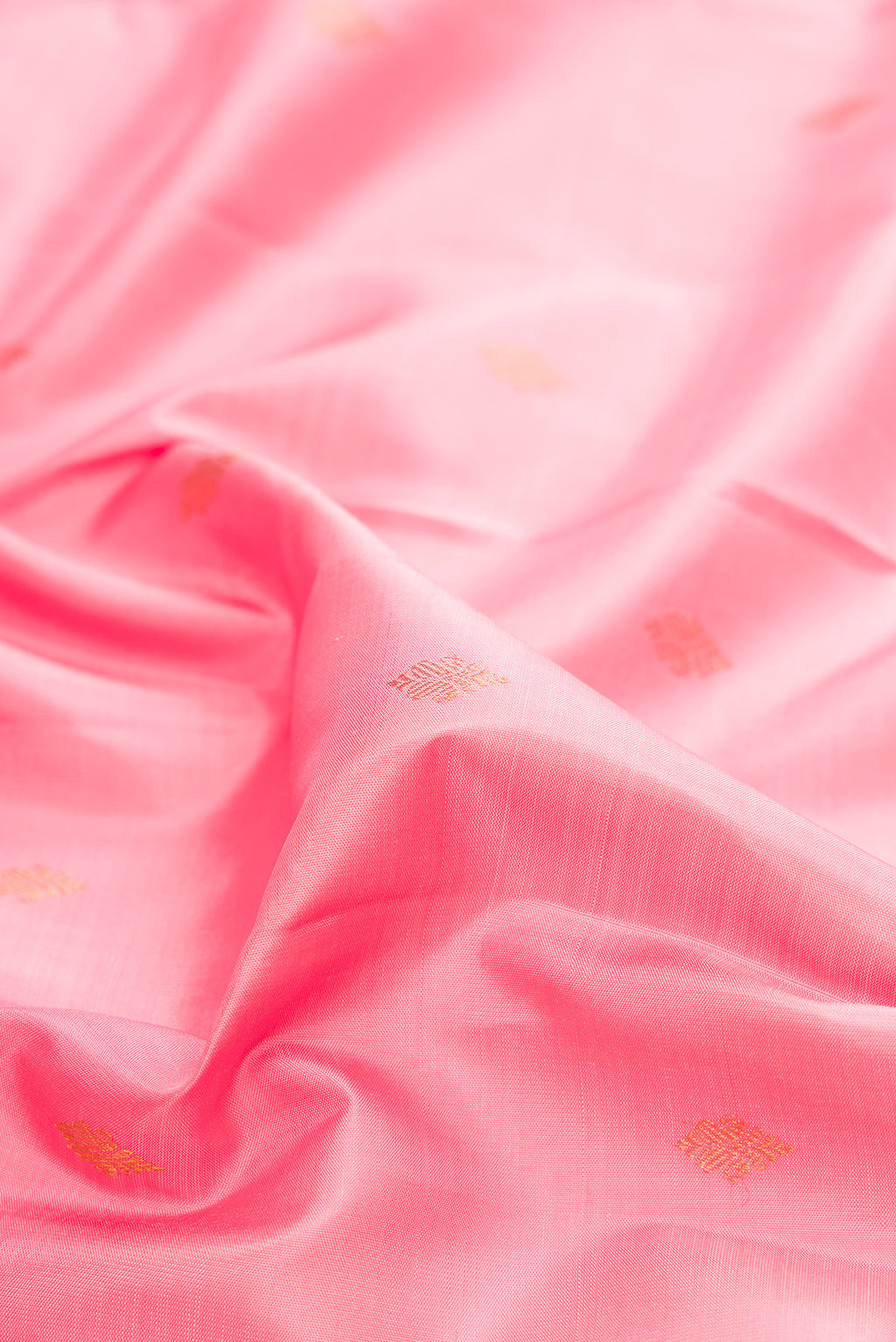 Close up of Pure Silk Rose pink Kanjivaram Saree with Zari Butta on the body and Zari Border.  displaying folds