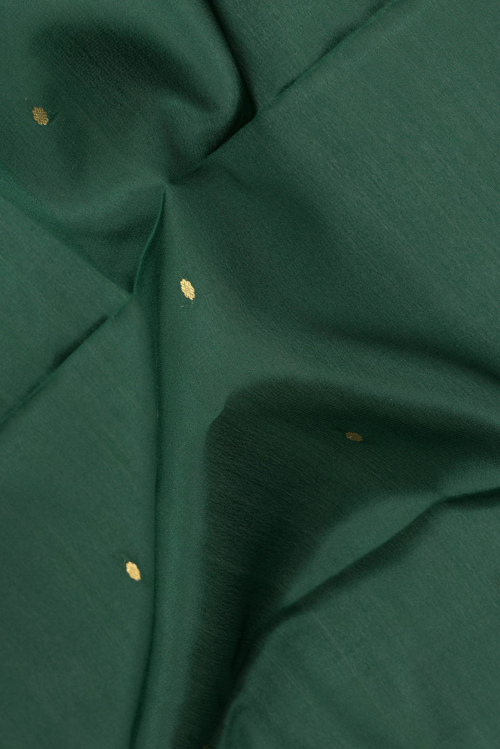 Close up of Pure Silk Bottle Green Mysore Silk Saree with Zari Butta on the body and Zari Border.  displaying folds