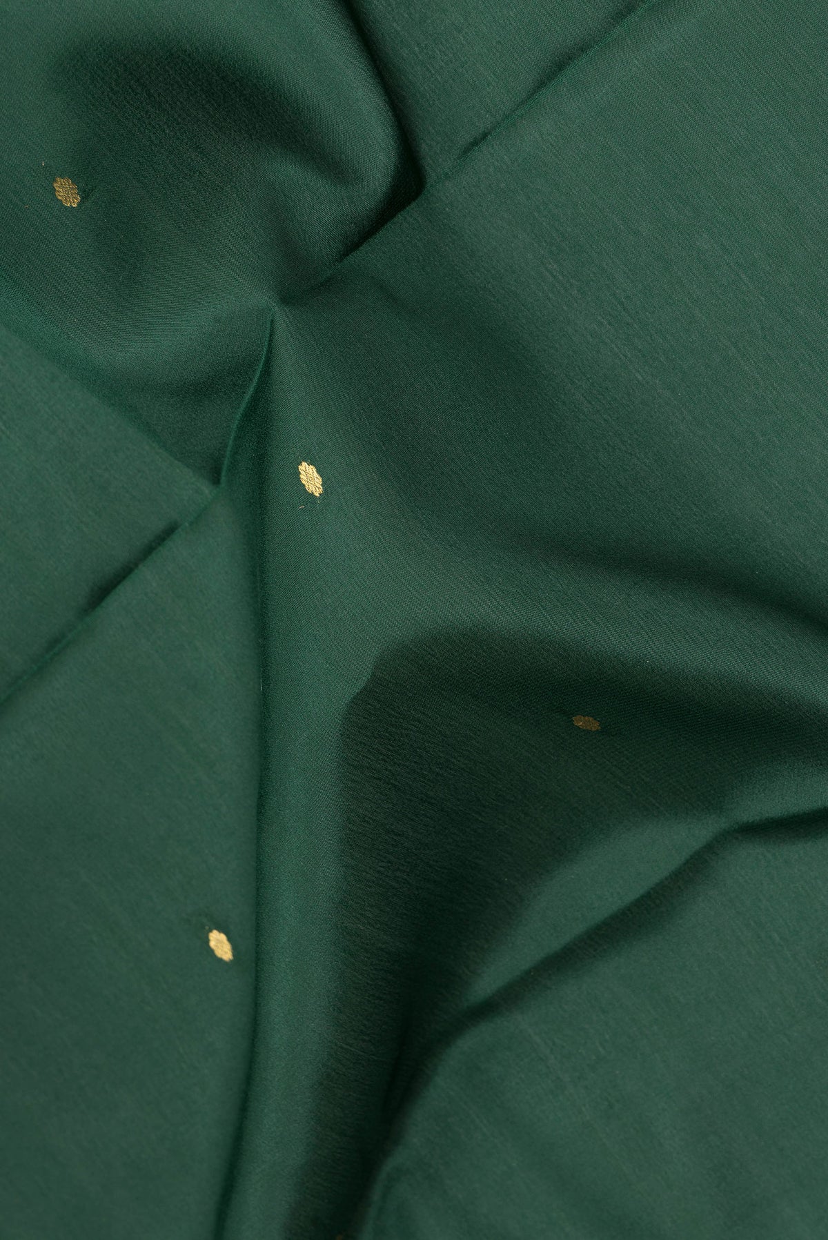 Close up of Pure Silk Bottle Green Mysore Silk Saree with Zari Butta on the body and Zari Border.  displaying folds