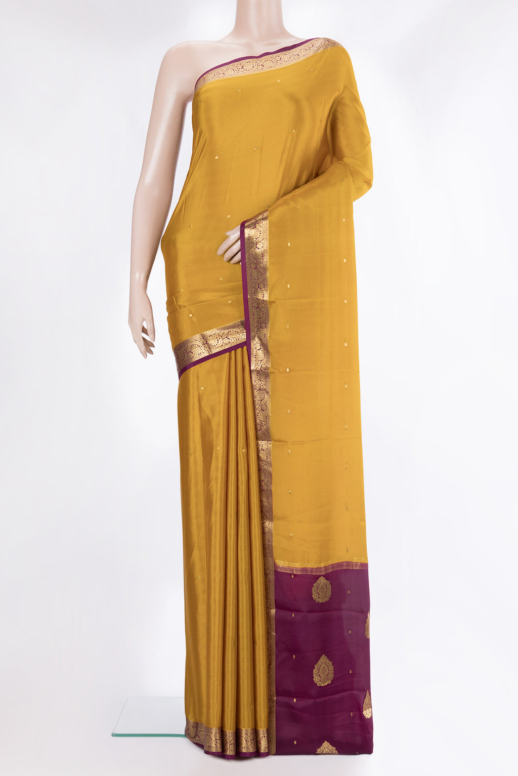 Mustard Mysore Crepe Saree with Zari Butta on the body and Zari Border.  displayed on a mannequin