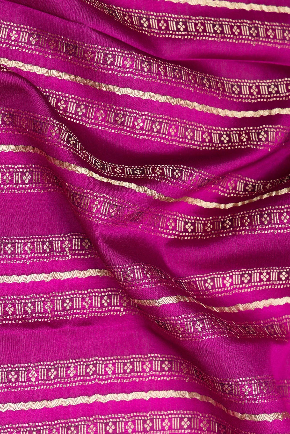Close up of Magenta Dual Tone Banarasi Georgette Saree with Zari Brocade on the body and Plain Border.  displaying folds