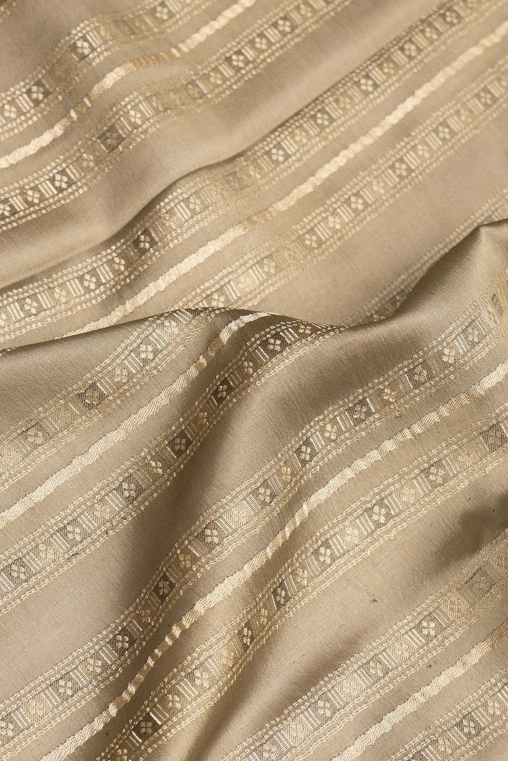 Close up of Pure Silk Brown Dual Tone Banarasi Georgette Saree with Zari Brocade on the body and Zari Border.  displaying folds