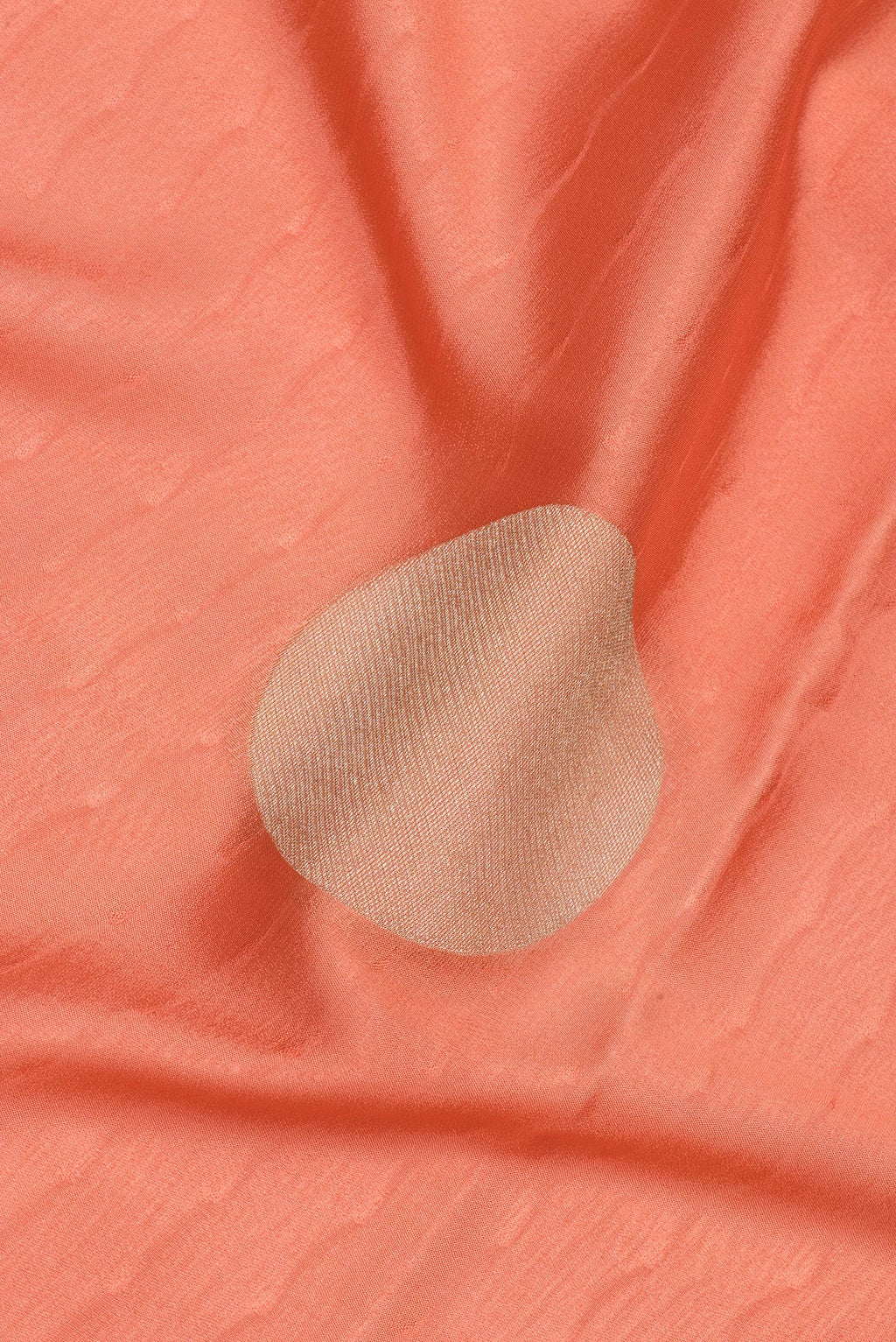 Close up of Peach Mysore Crepe Saree with Zari Butta on the body and Zari Border.  displaying folds