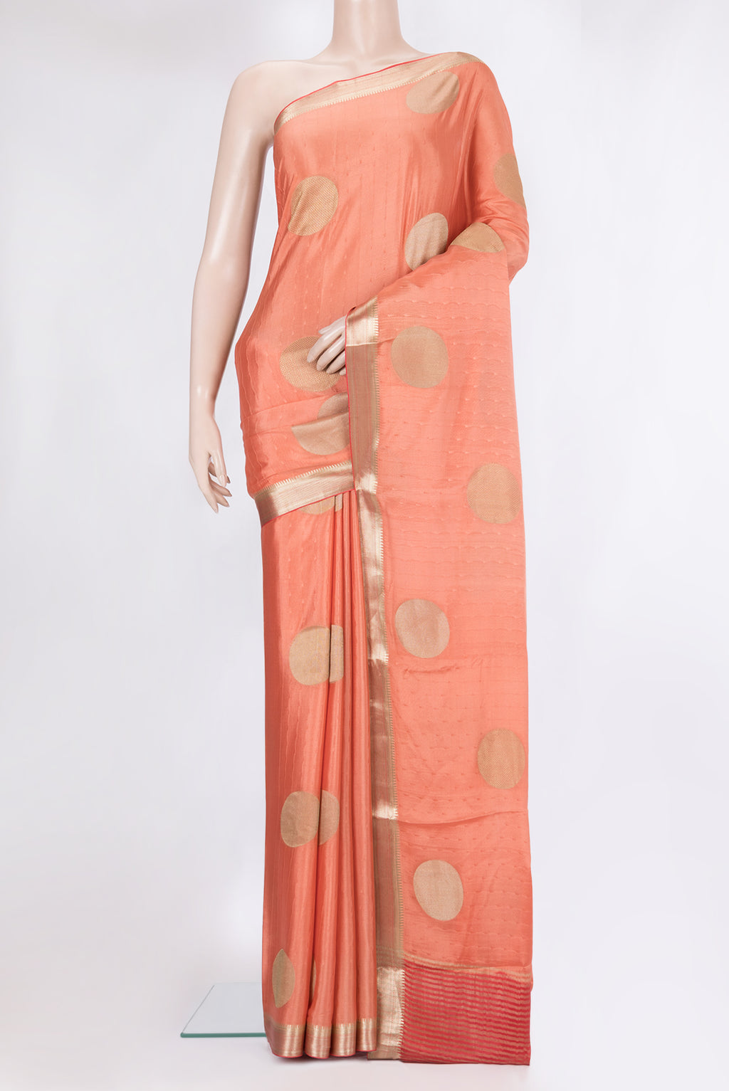 Peach Mysore Crepe Saree with Zari Butta on the body and Zari Border.  displayed on a mannequin