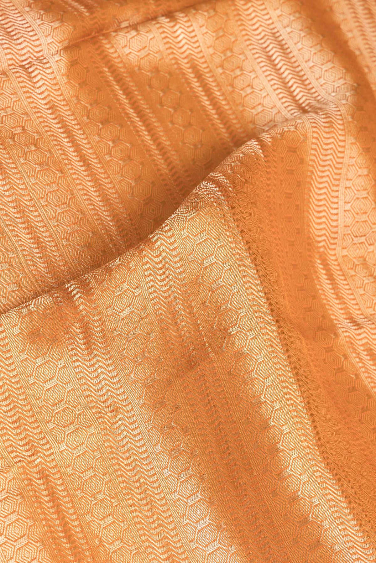 Close up of Pure Silk Orange Dual Tone Banarasi Georgette Saree with Zari Brocade on the body and Zari Border.  displaying folds
