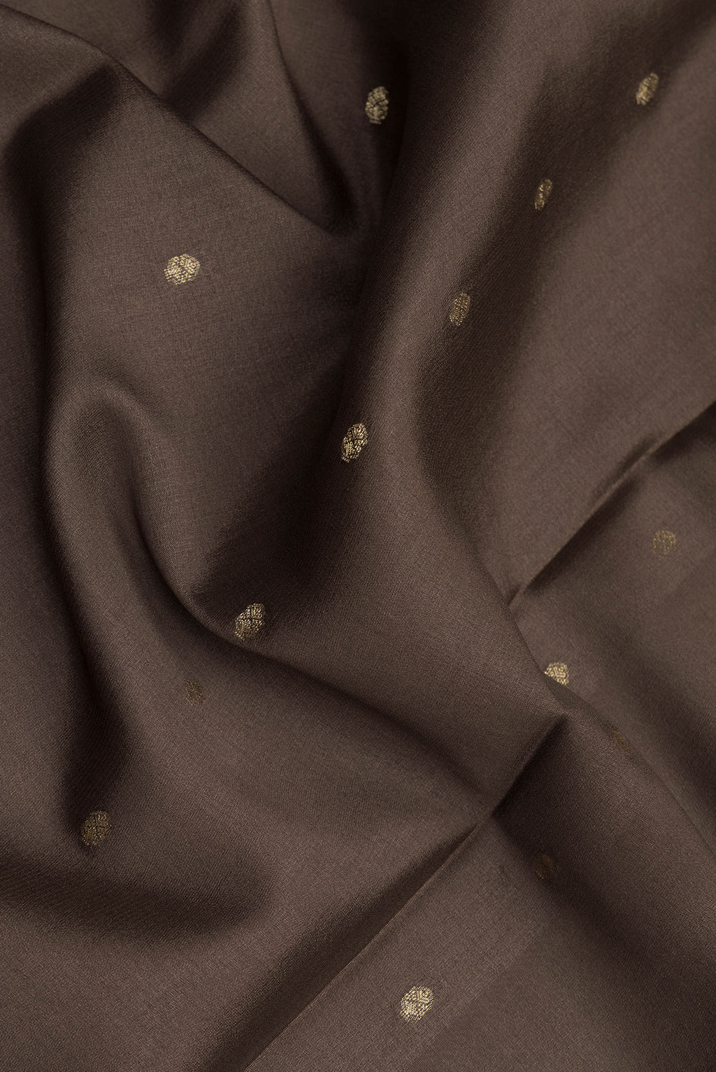 Close up of Brown Dual Tone Georgette Saree with Zari Butta on the body and Zari Border.  displaying folds