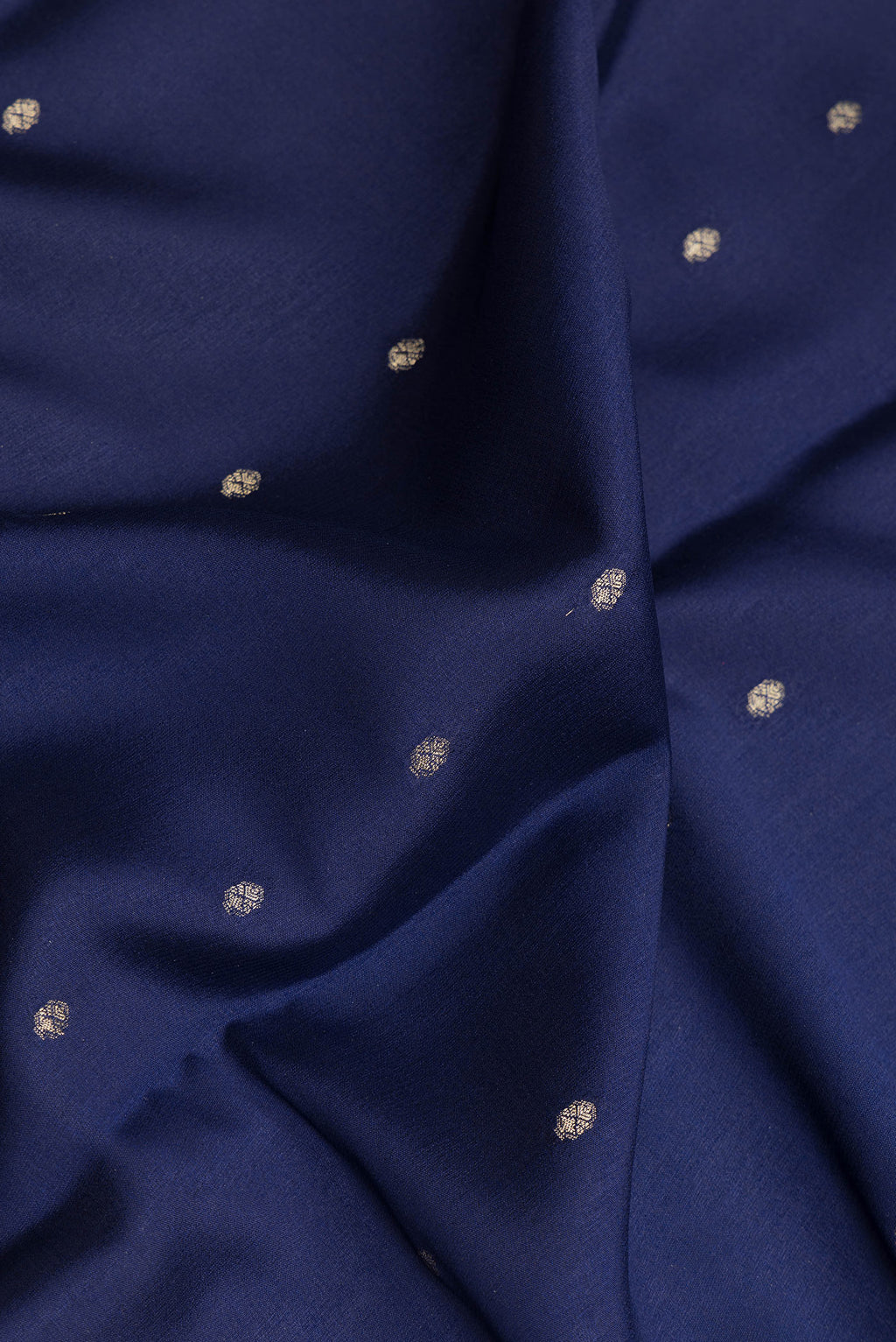 Close up of Navy Blue Dual Tone Georgette Saree with Zari Butta on the body and Zari Border.  displaying folds