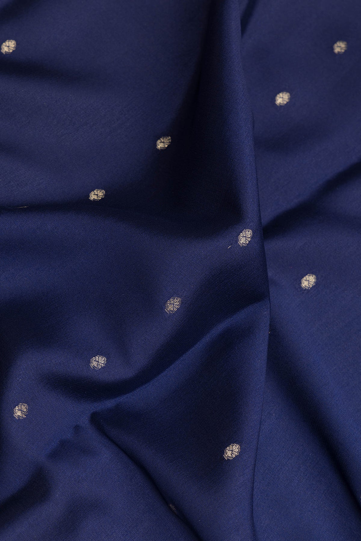 Close up of Navy Blue Dual Tone Georgette Saree with Zari Butta on the body and Zari Border.  displaying folds