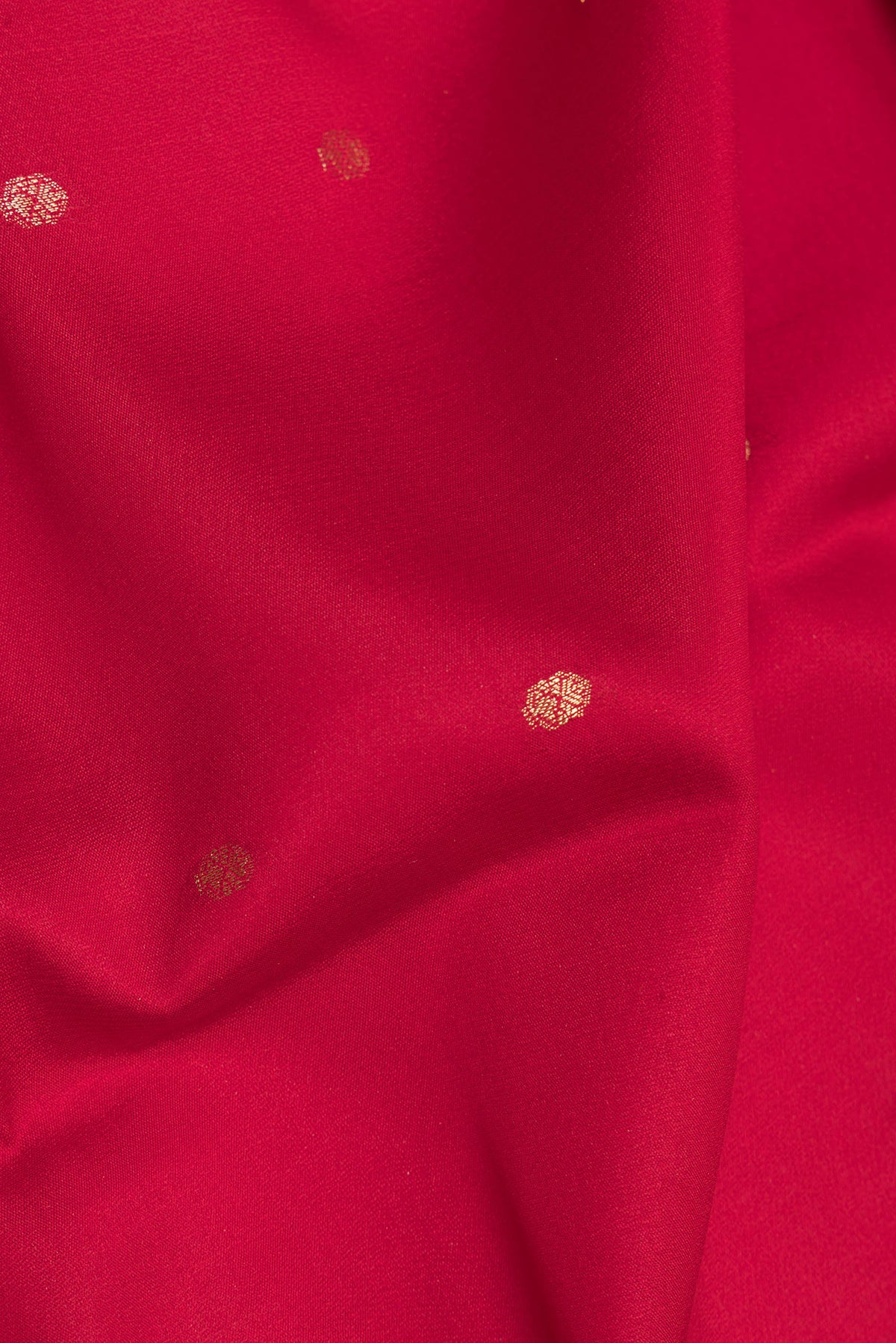 Close up of Red Dual Tone Georgette Saree with Zari Butta on the body and Zari Border.  displaying folds