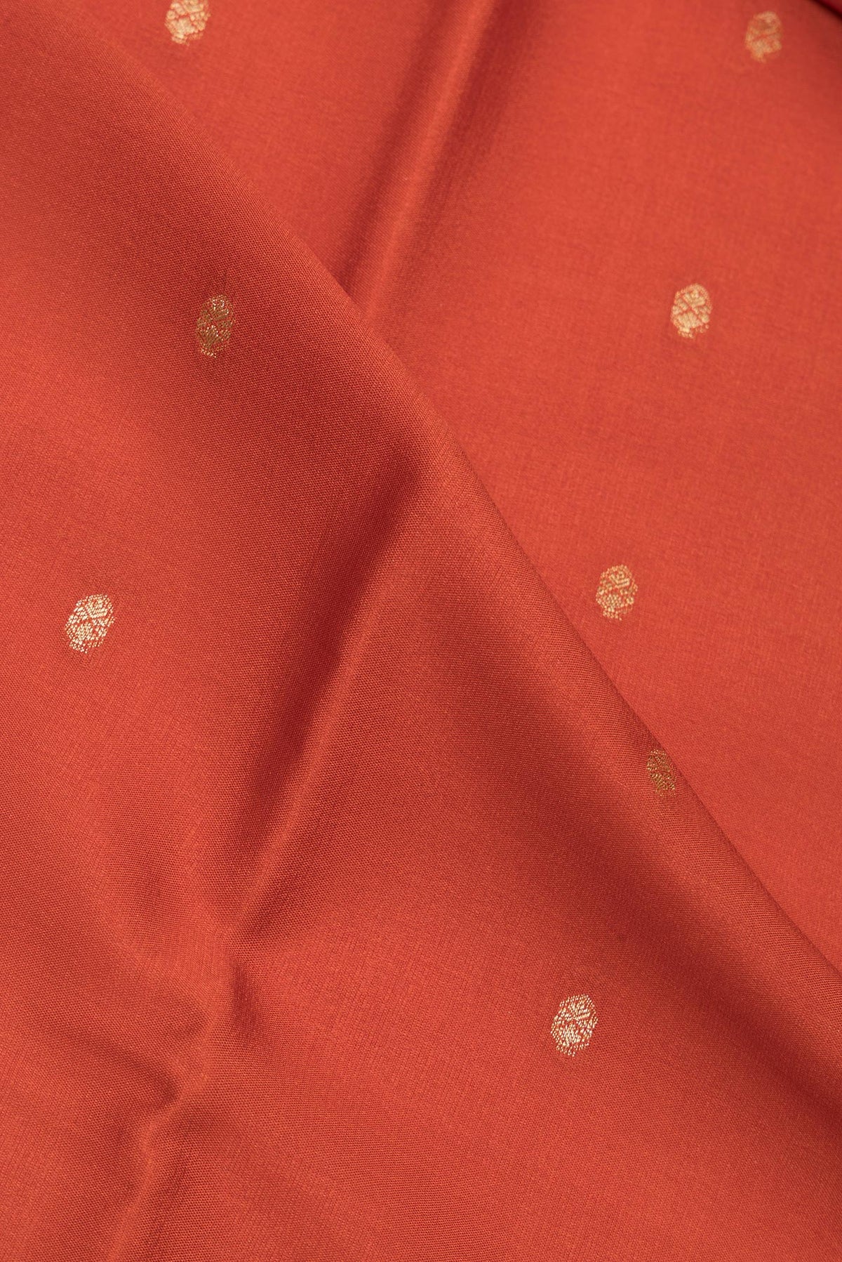 Close up of Brick Orange Dual Tone Georgette Saree with Zari Butta on the body and Zari Border.  displaying folds