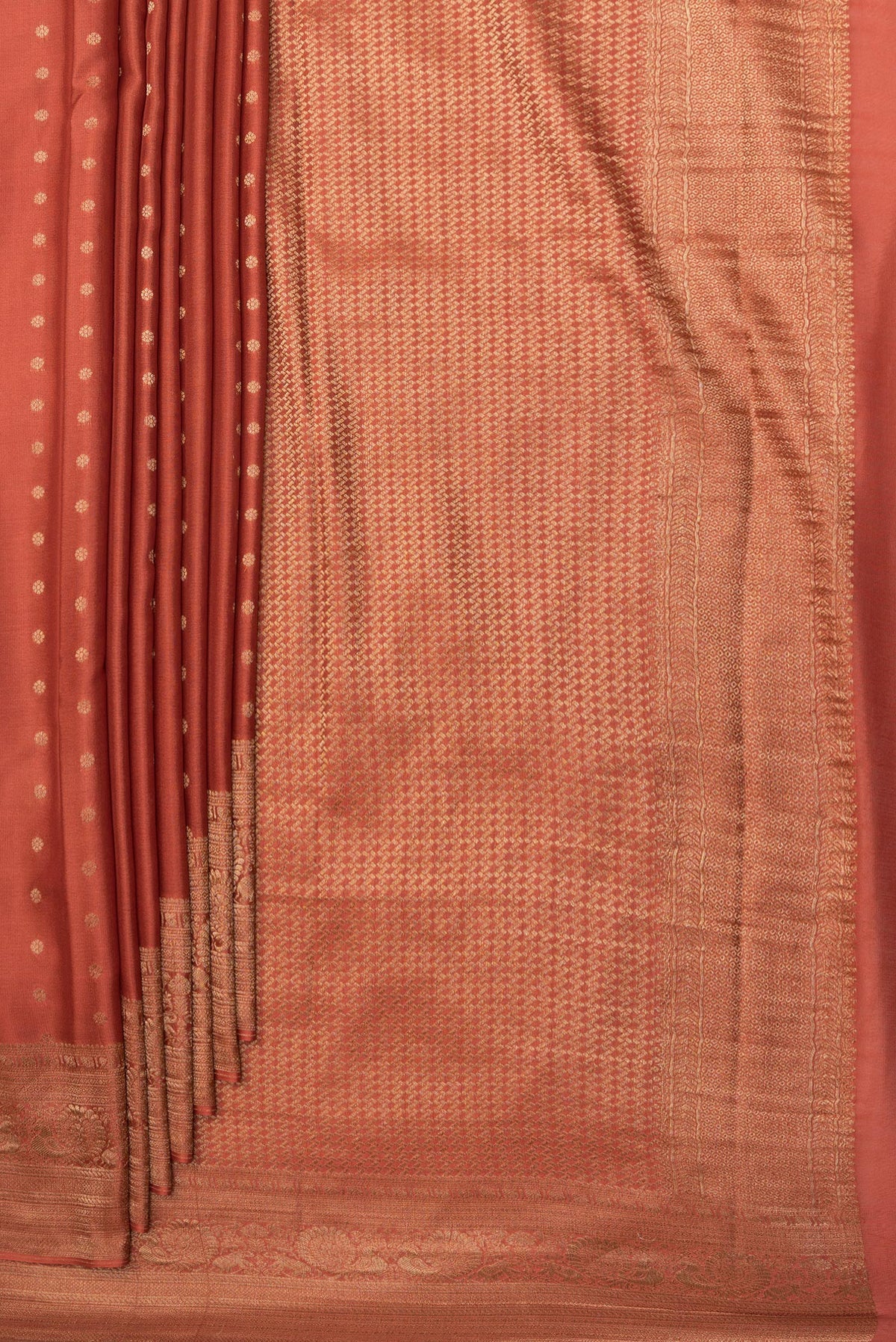 Pleats and pallu of Rust Dual Tone Georgette Saree with Zari Butta on the body and Zari Border. 