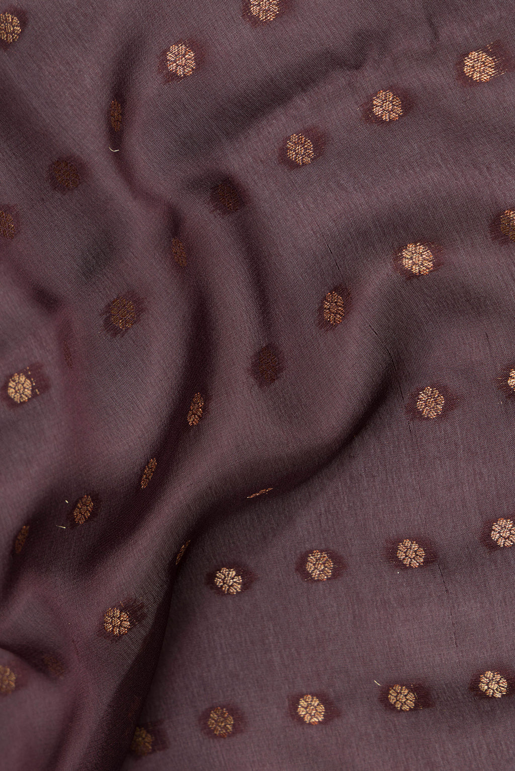 Close up of Pure Silk Bronze Dual Tone Banarasi Georgette Saree with Zari Brocade on the body and Zari Border.  displaying folds