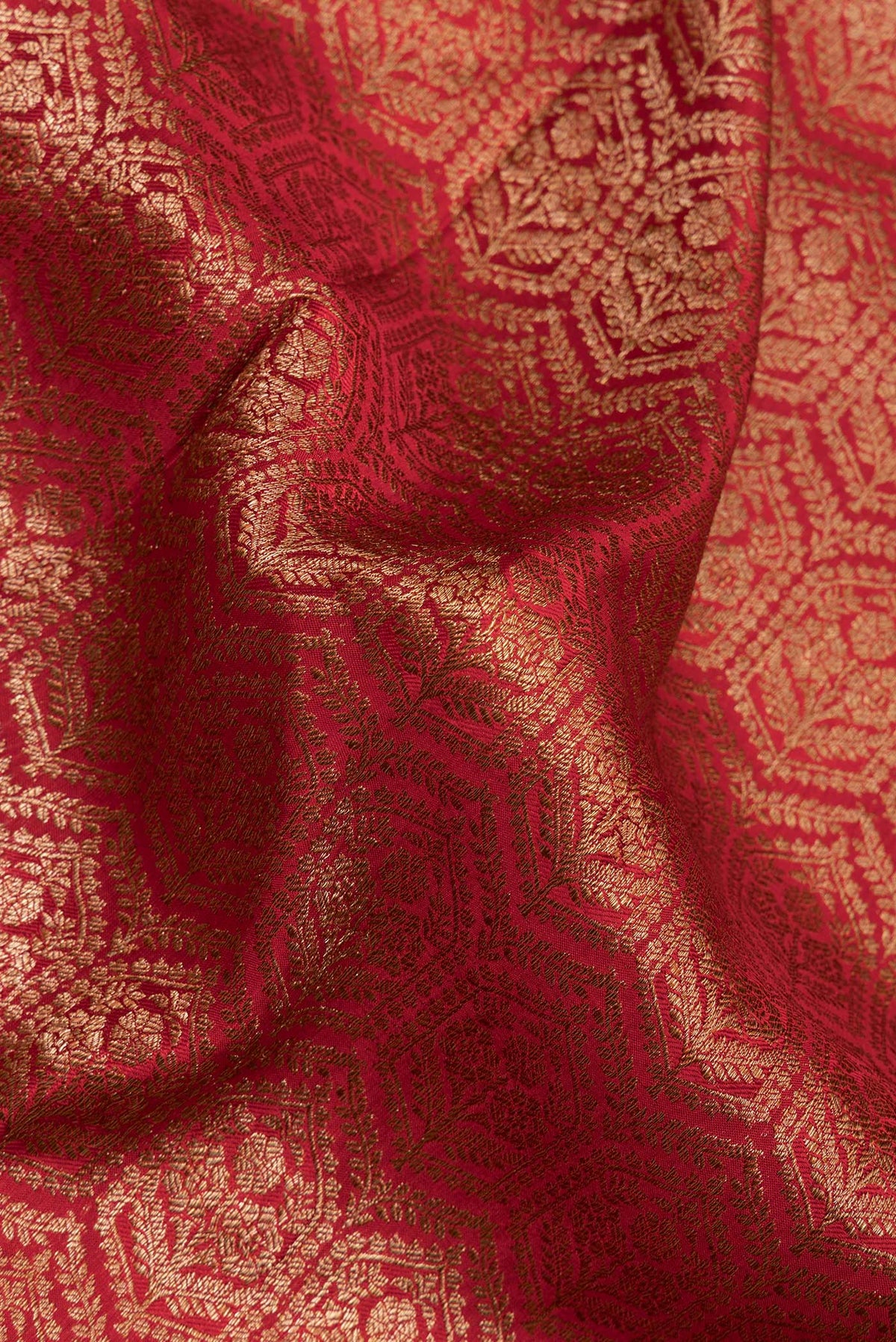 Close up of Red Dual Tone Mysore Crepe Saree with Zari Brocade on the body and Zari Border.  displaying folds