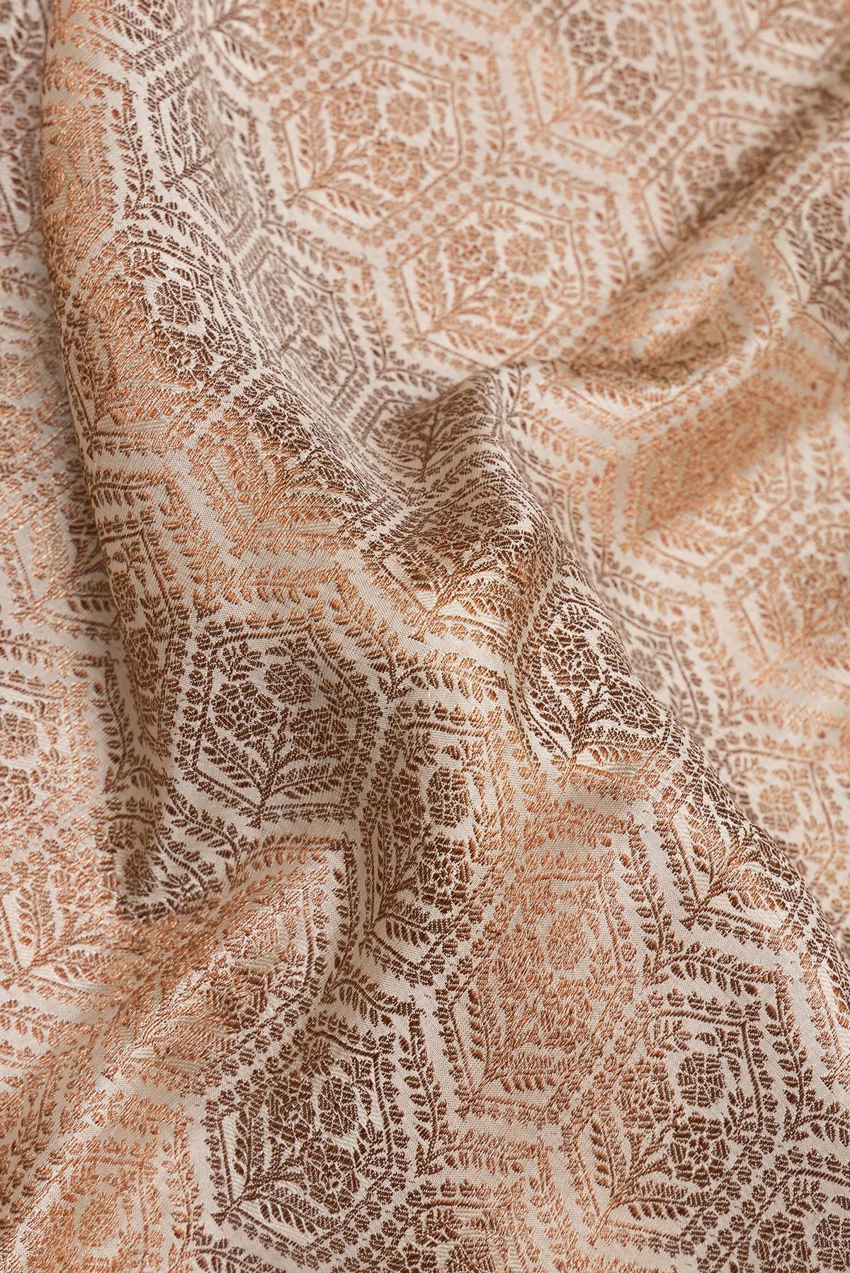 Close up of Off White Crepe Saree with Zari Brocade on the body and Zari Border.  displaying folds