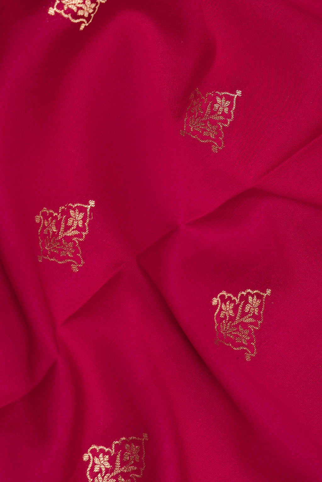 Close up of Dark Pink Georgette Saree with Zari Butta on the body and Zari Border.  displaying folds