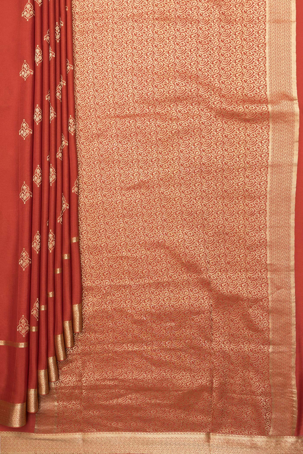 Pleats and pallu of Pure Silk Rust Dual Tone Banarasi Georgette Saree with Zari Butta on the body and Zari Border. 