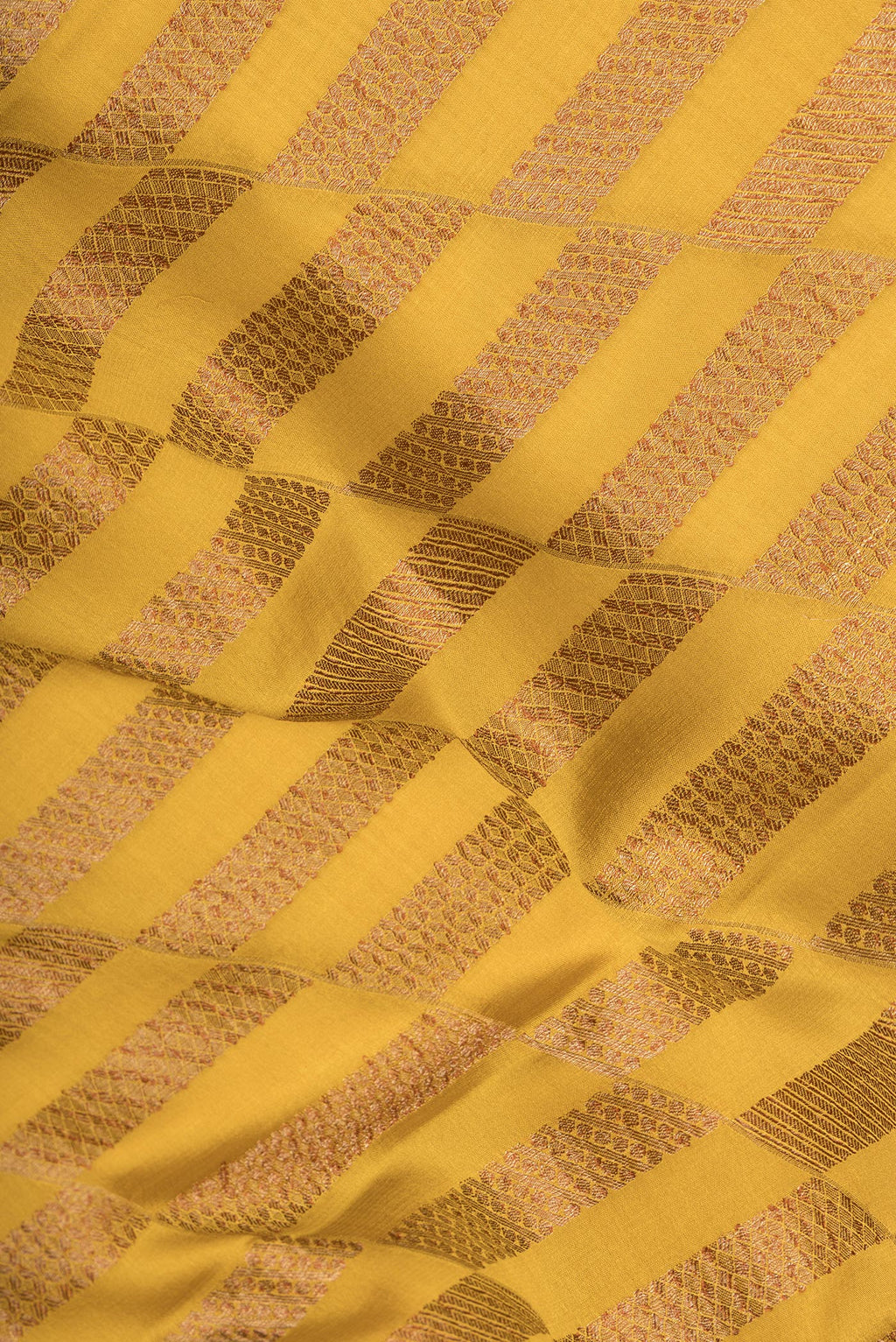 Close up of Mustard Dual Tone Banarasi Georgette Saree with Zari Brocade on the body and Zari Border.  displaying folds