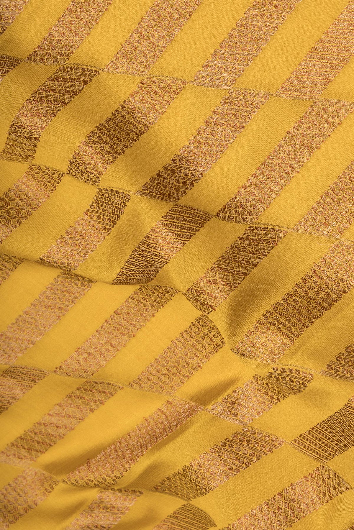 Close up of Mustard Dual Tone Banarasi Georgette Saree with Zari Brocade on the body and Zari Border.  displaying folds