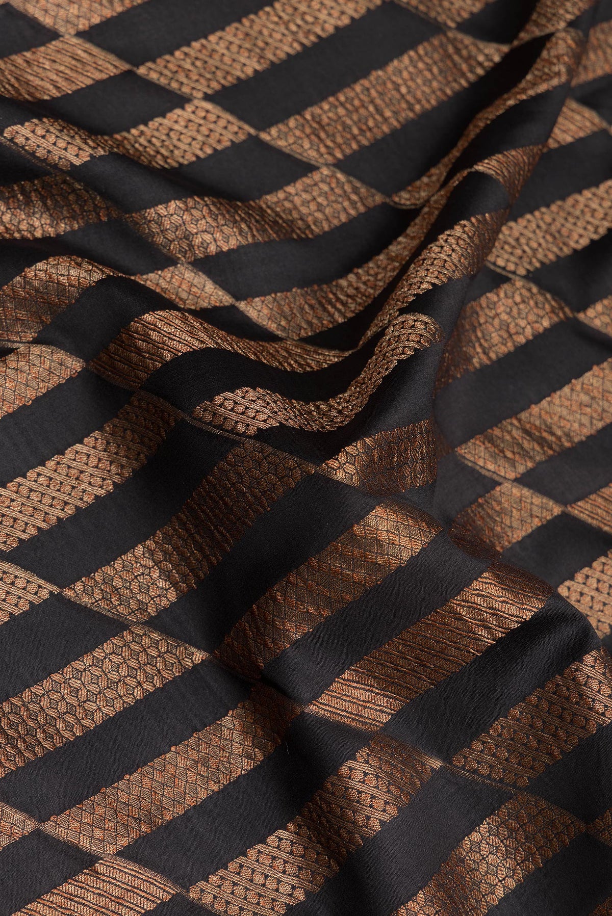 Close up of Pure Silk Black Dual Tone Banarasi Georgette Saree with Zari Brocade on the body and Zari Border.  displaying folds