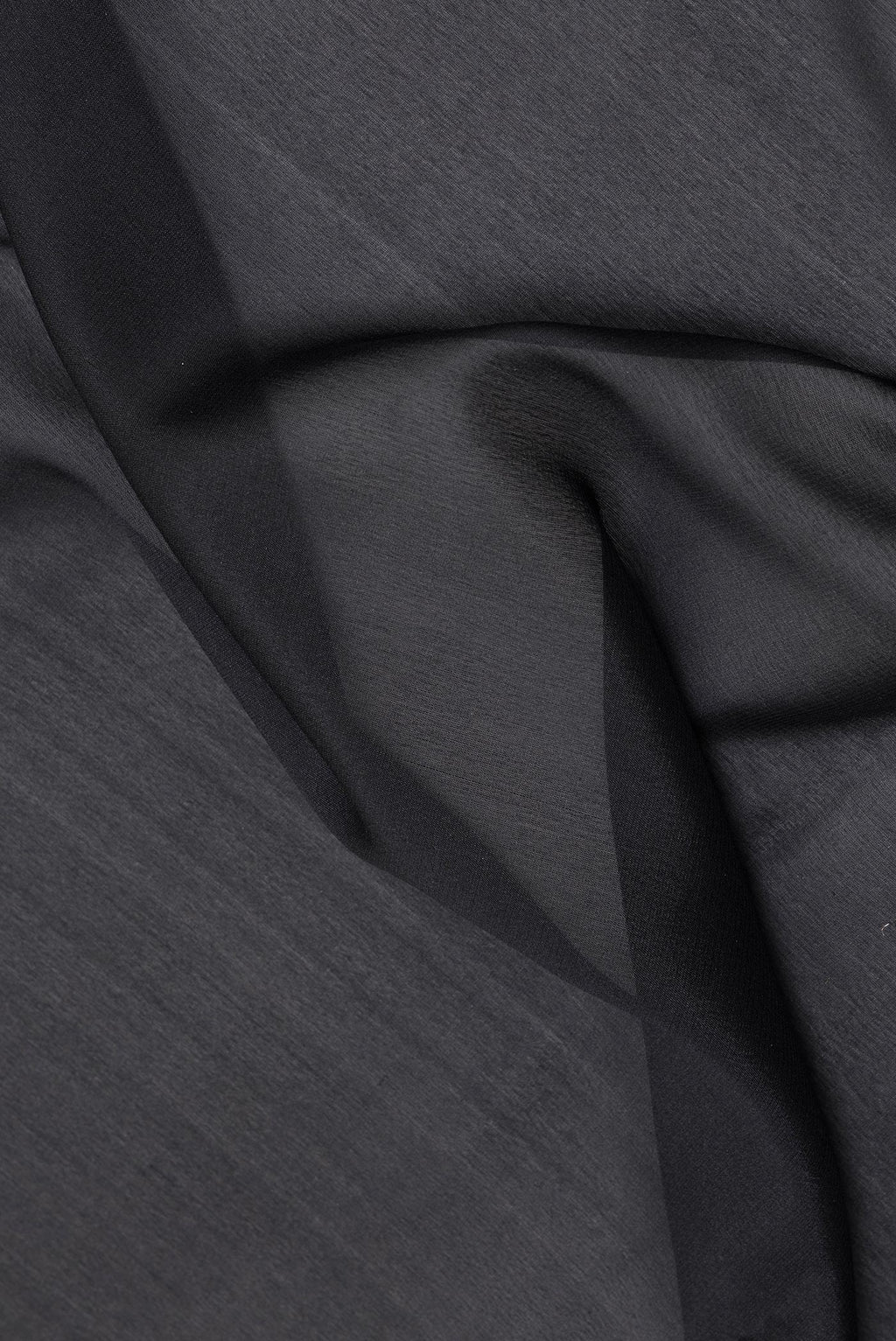 Close up of Black Banarasi Georgette Saree with Plain Body and Fancy Border.  displaying folds