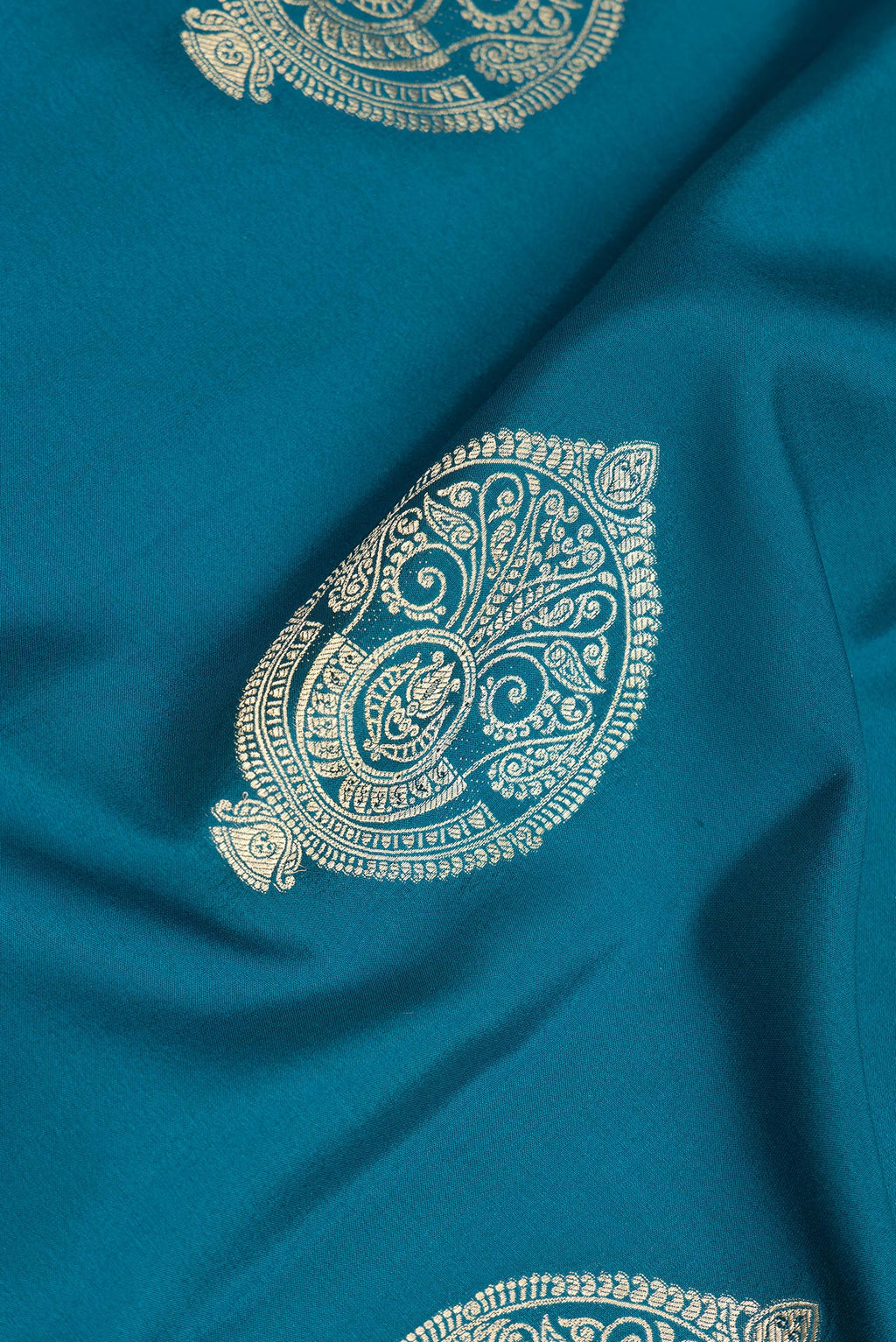 Close up of Pure Silk Peacock Blue Dual Tone Banarasi Georgette Saree with Zari Butta on the body and Zari Border.  displaying folds