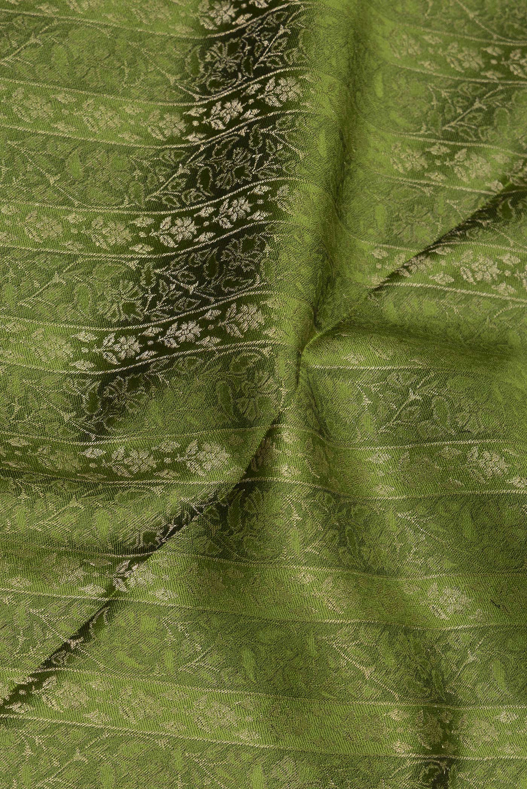 Close up of Mehandi Green Georgette Saree with Zari Brocade on the body and Zari Border.  displaying folds