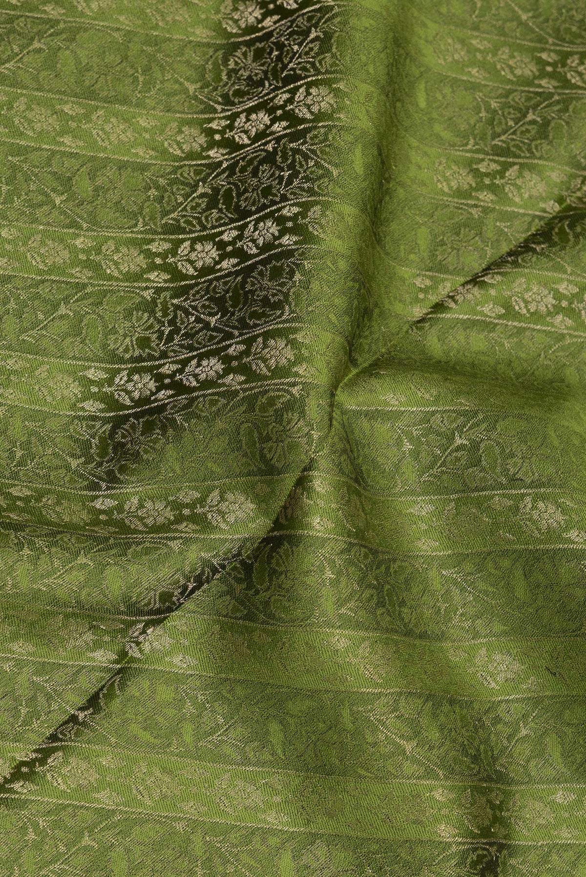 Close up of Mehandi Green Georgette Saree with Zari Brocade on the body and Zari Border.  displaying folds