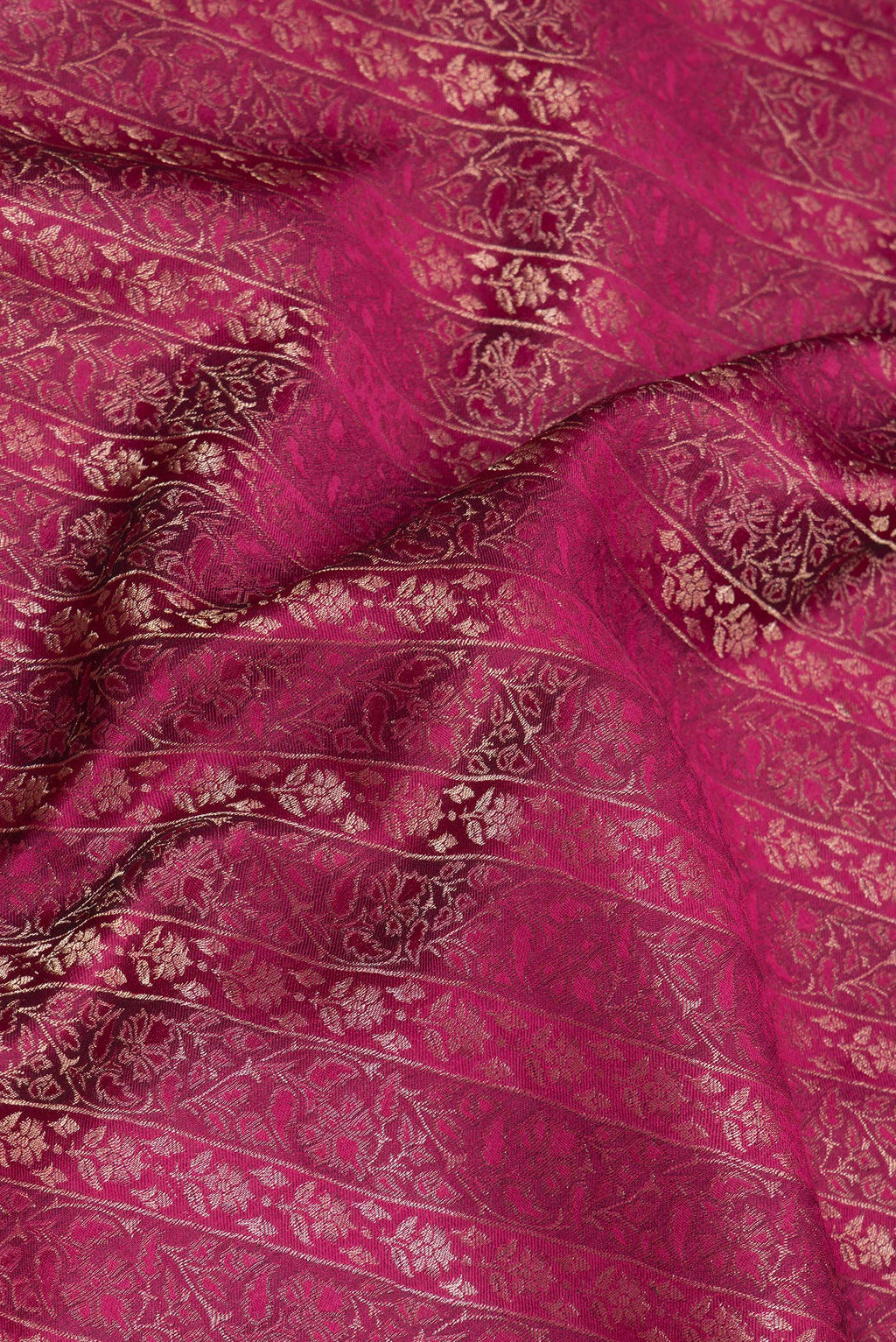 Close up of Magenta Georgette Saree with Zari Brocade on the body and Zari Border.  displaying folds