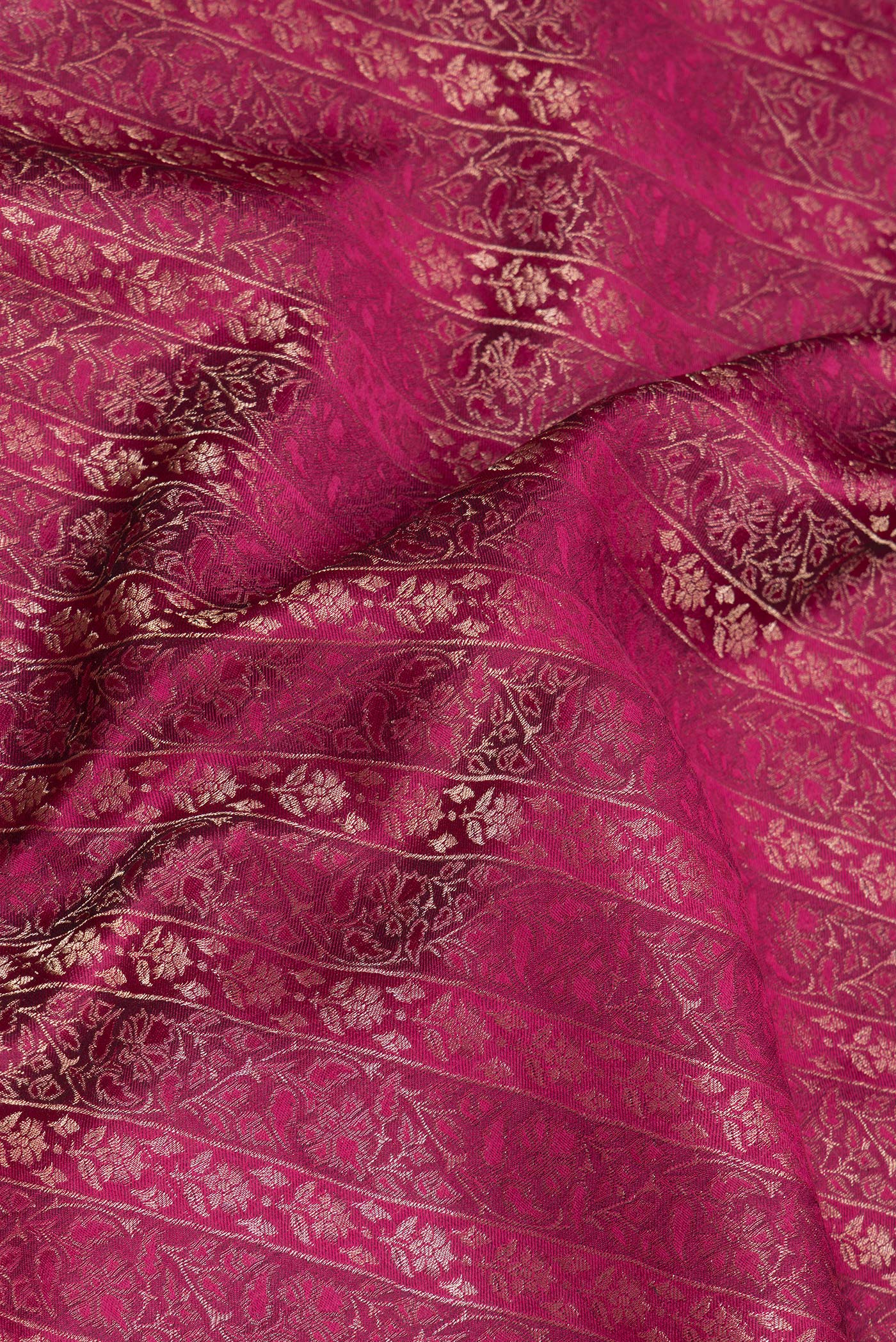 Close up of Magenta Georgette Saree with Zari Brocade on the body and Zari Border.  displaying folds