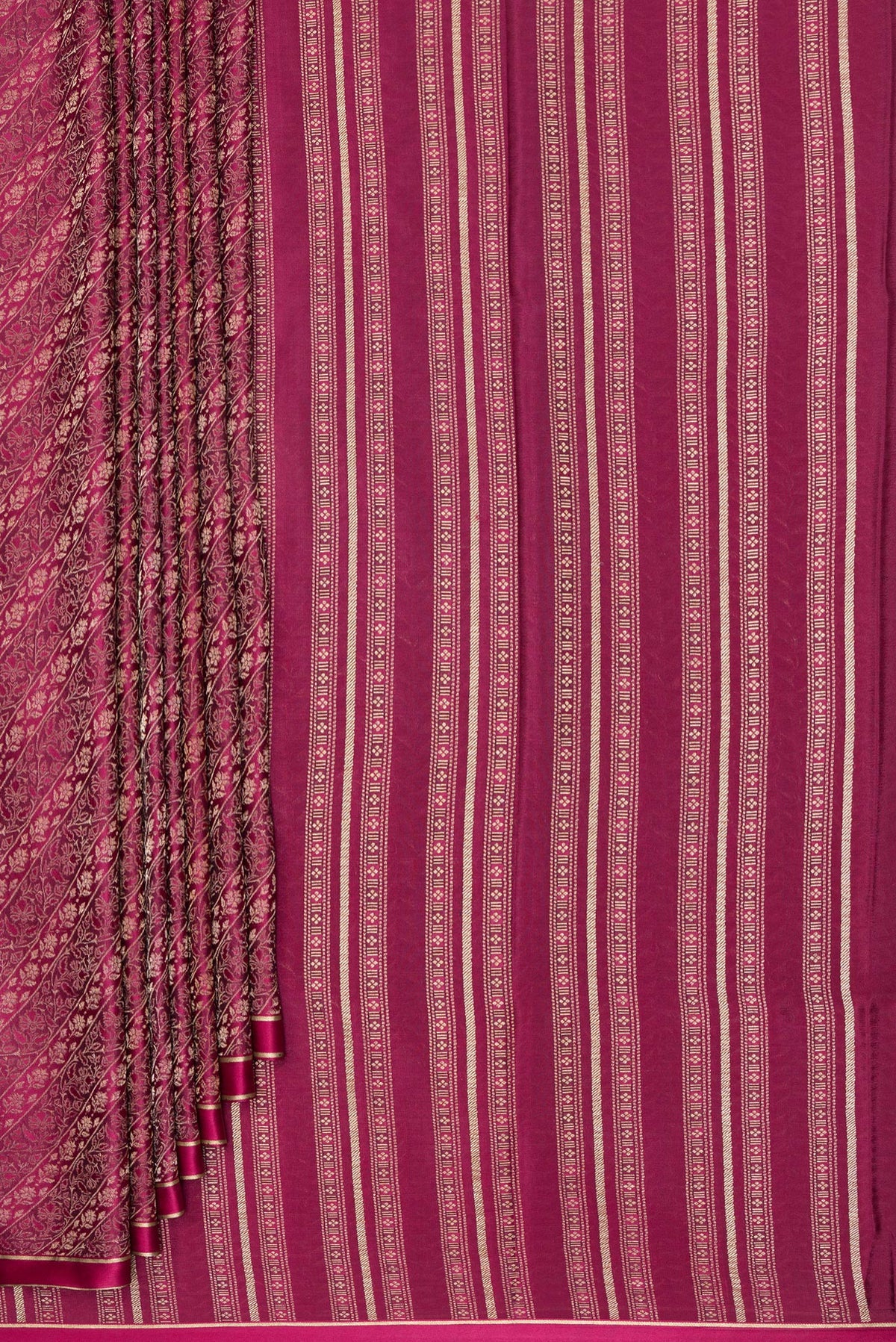 Pleats and pallu of Magenta Georgette Saree with Zari Brocade on the body and Zari Border. 
