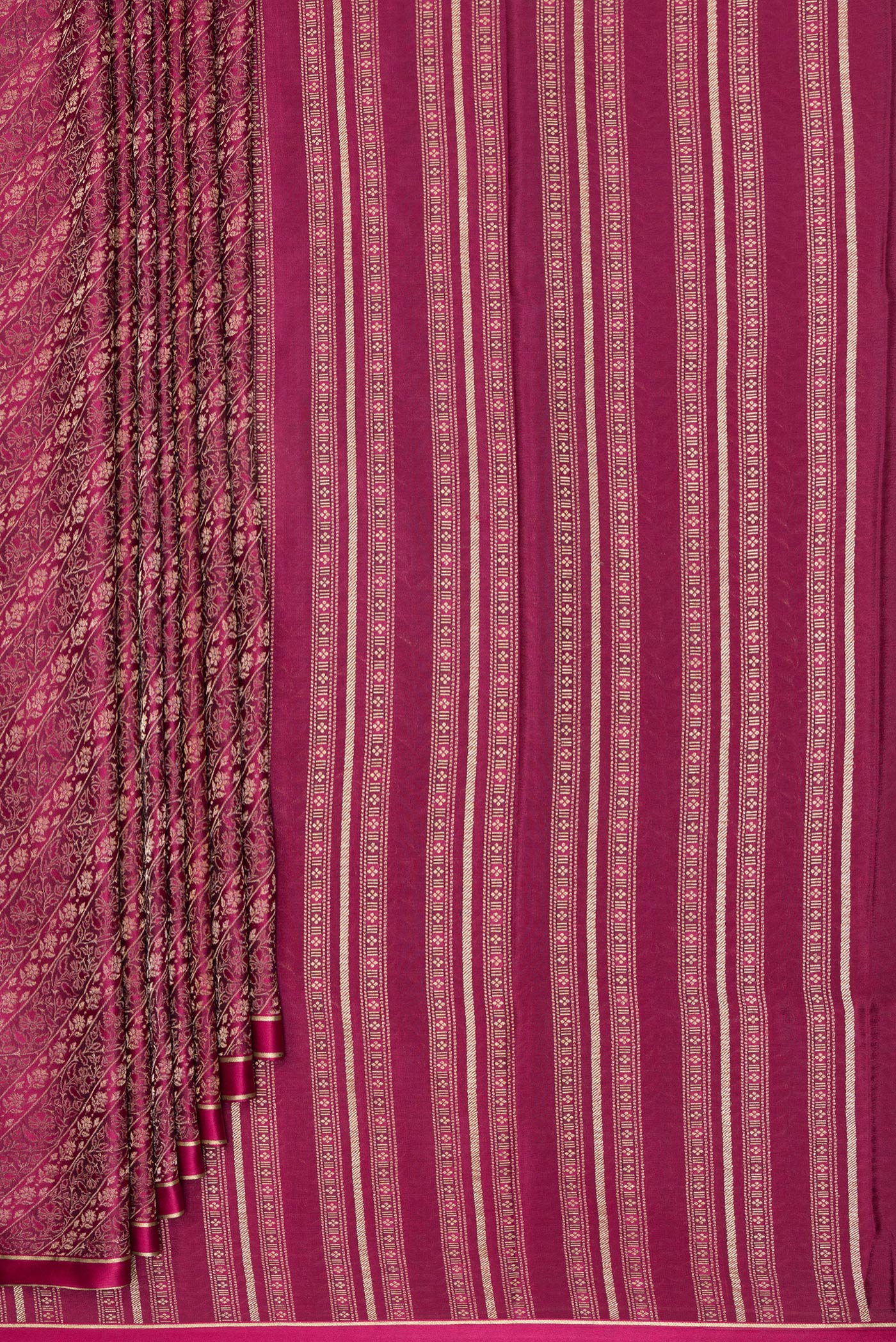 Pleats and pallu of Magenta Georgette Saree with Zari Brocade on the body and Zari Border. 