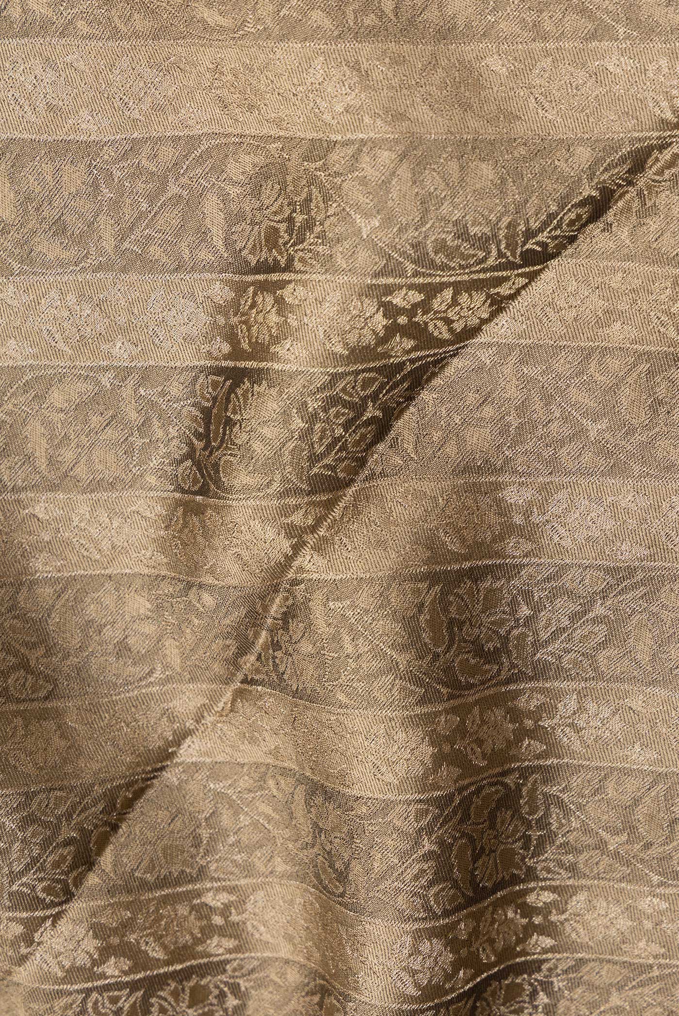 Close up of Brown Dual Tone Banarasi Georgette Saree with Zari Brocade on the body and Zari Border.  displaying folds