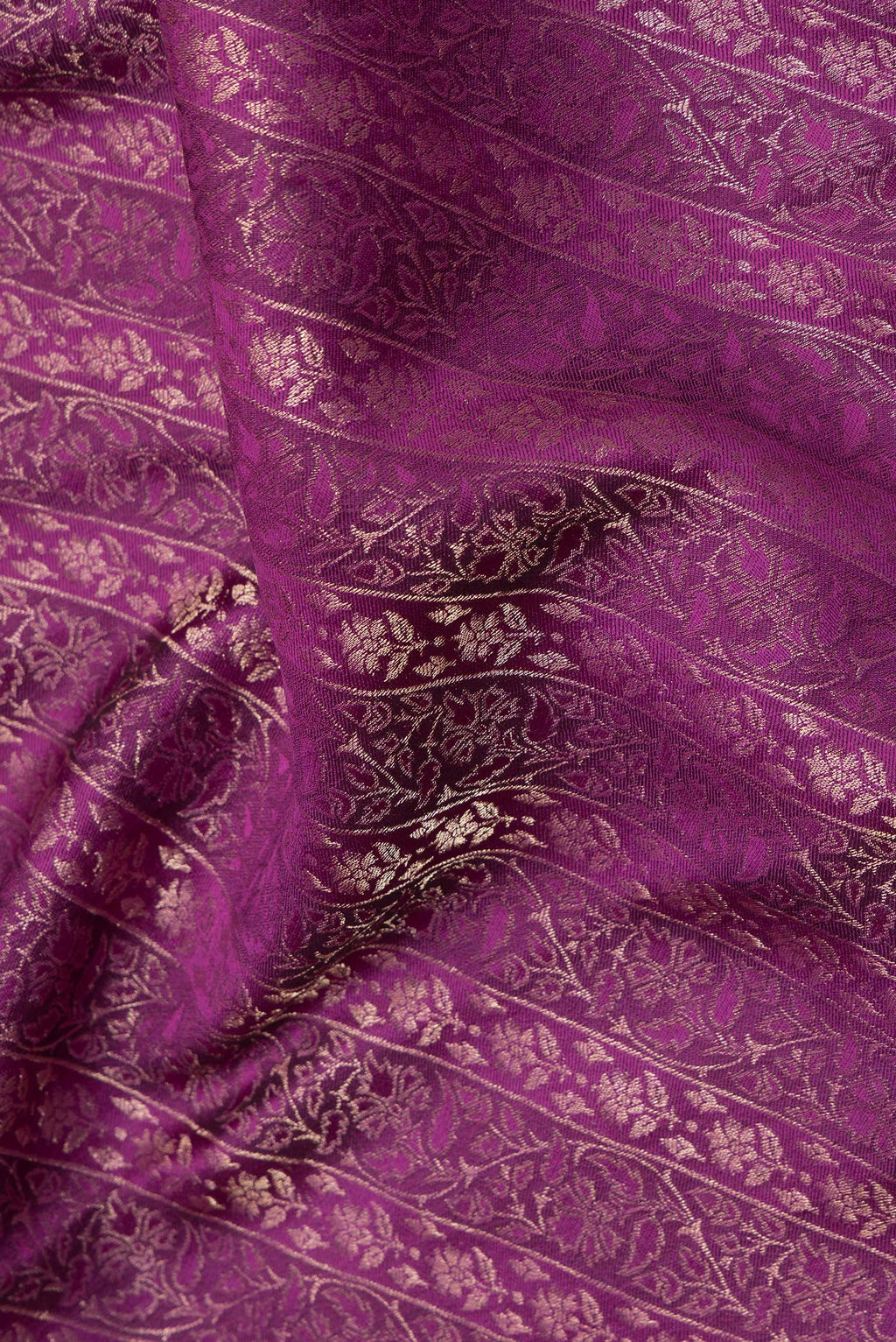 Close up of Magenta Dual Tone Banarasi Georgette Saree with Zari Brocade on the body and Zari Border.  displaying folds