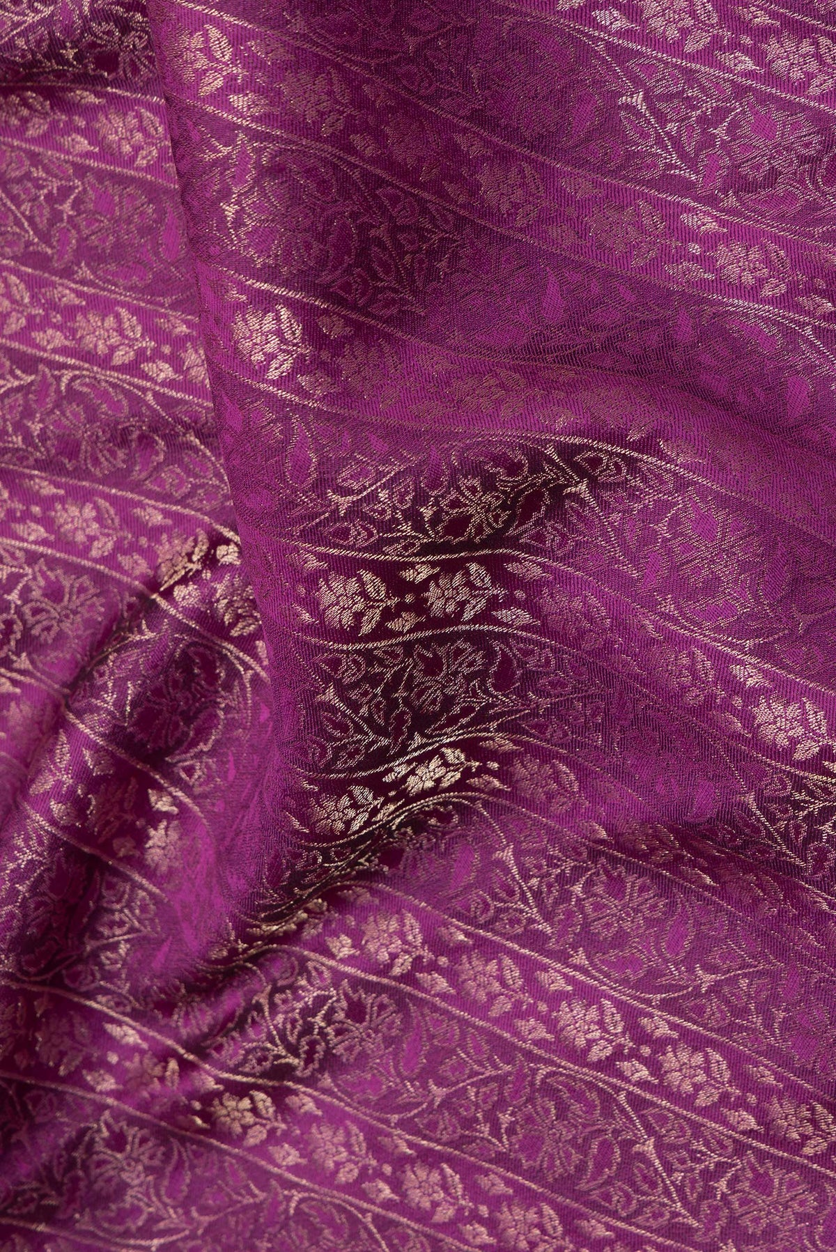 Close up of Magenta Dual Tone Banarasi Georgette Saree with Zari Brocade on the body and Zari Border.  displaying folds