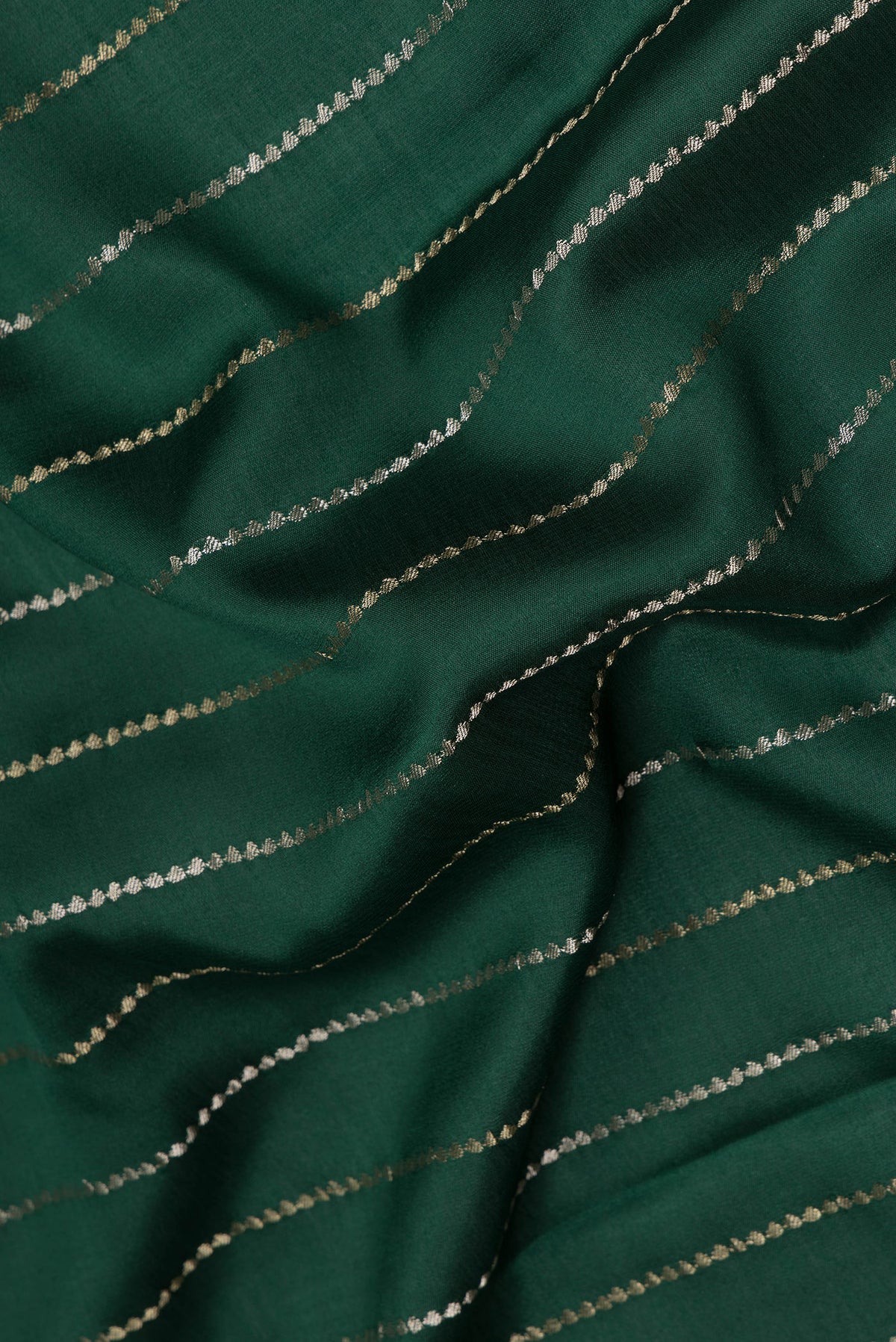 Close up of Pure Silk Bottle Green Dual Tone Banarasi Georgette Saree with Stripes on the body and Zari Border.  displaying folds