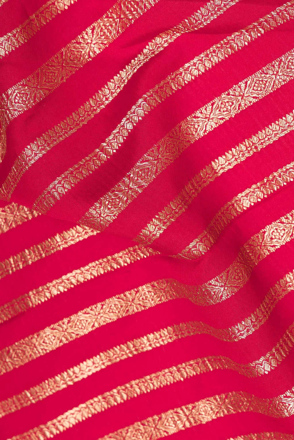 Close up of Red Mysore Crepe Saree with Stripes on the body and Zari Border.  displaying folds