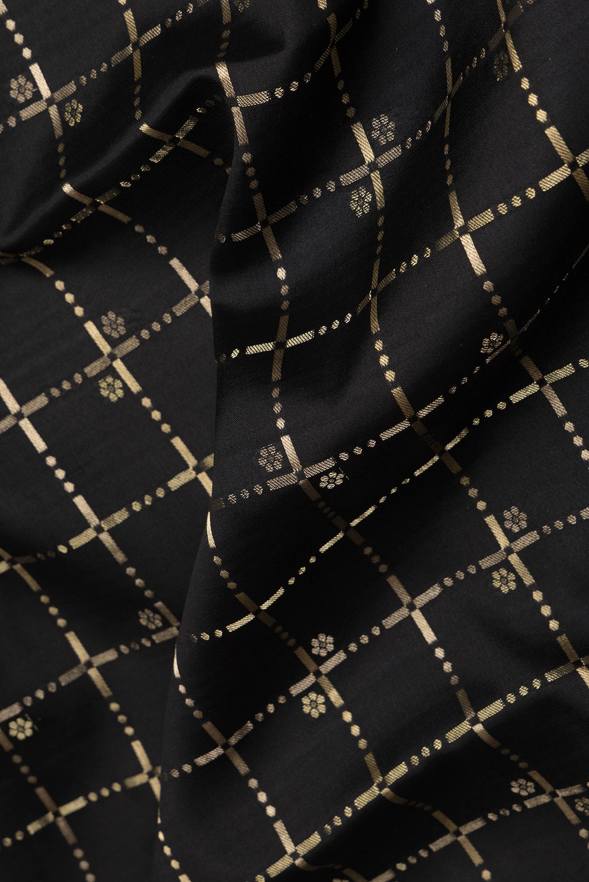 Close up of Black Dual Tone Georgette Saree with Checked design on the body and Zari Border.  displaying folds