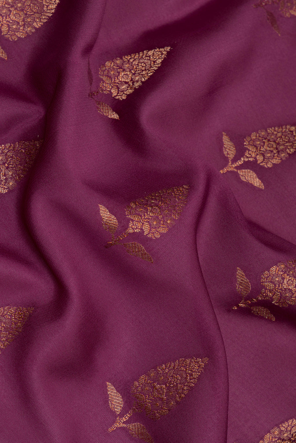 Close up of Magenta Georgette Saree with Zari Brocade on the body and Zari Border.  displaying folds
