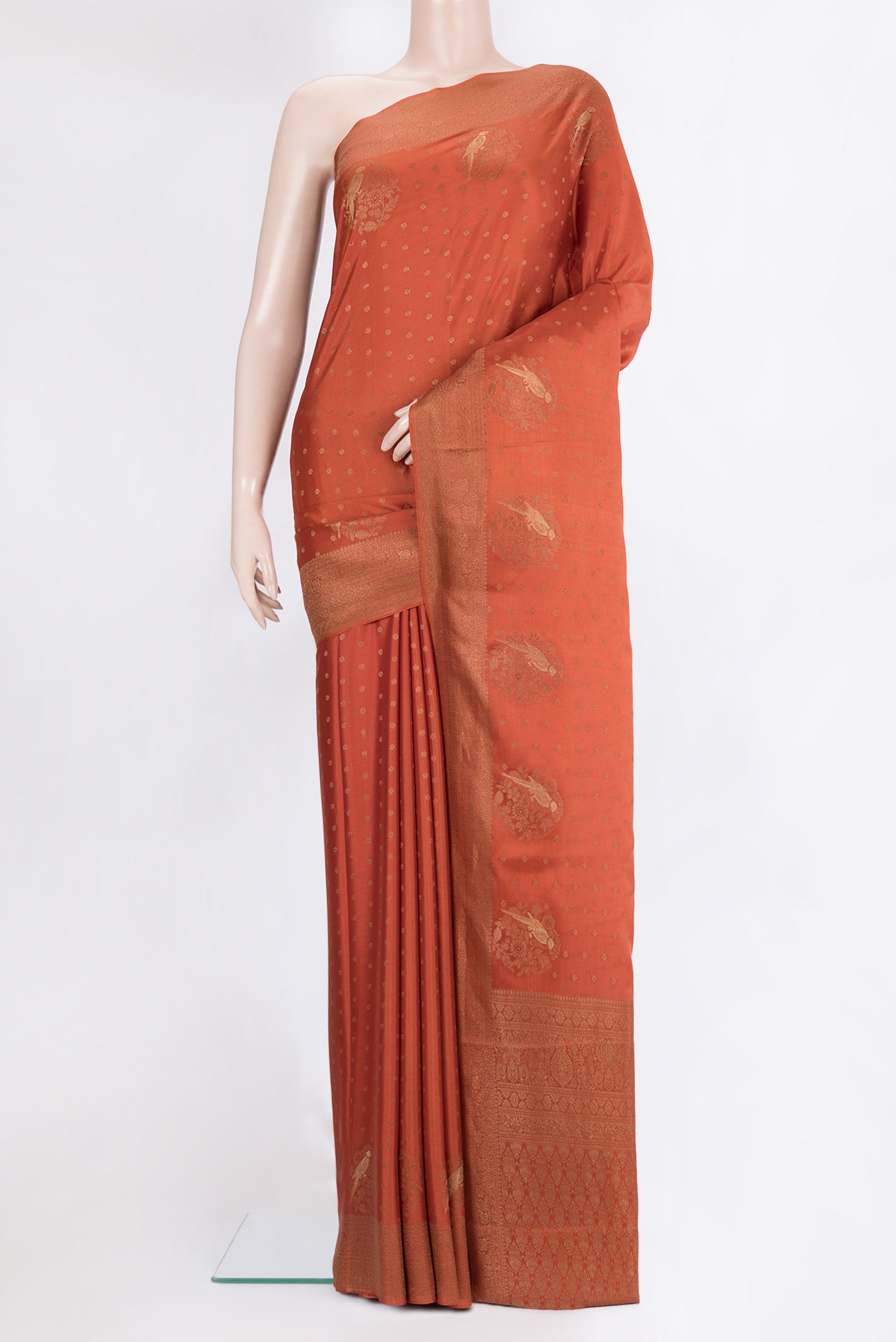 Rust Dual Tone Banarasi Georgette Saree with Zari Butta on the body and Zari Border.  displayed on a mannequin