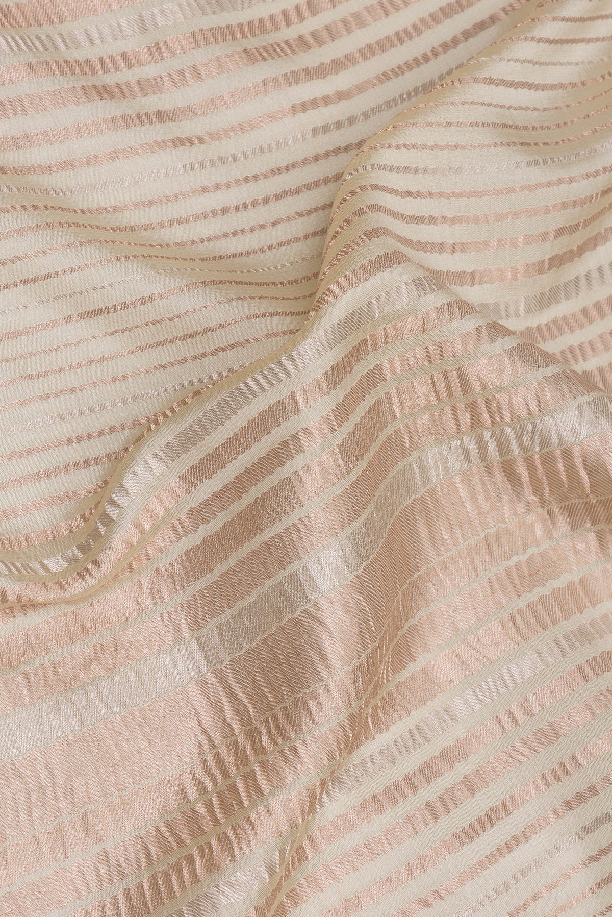 Close up of Beige Georgette Saree with Stripes on the body and Without Border.  displaying folds