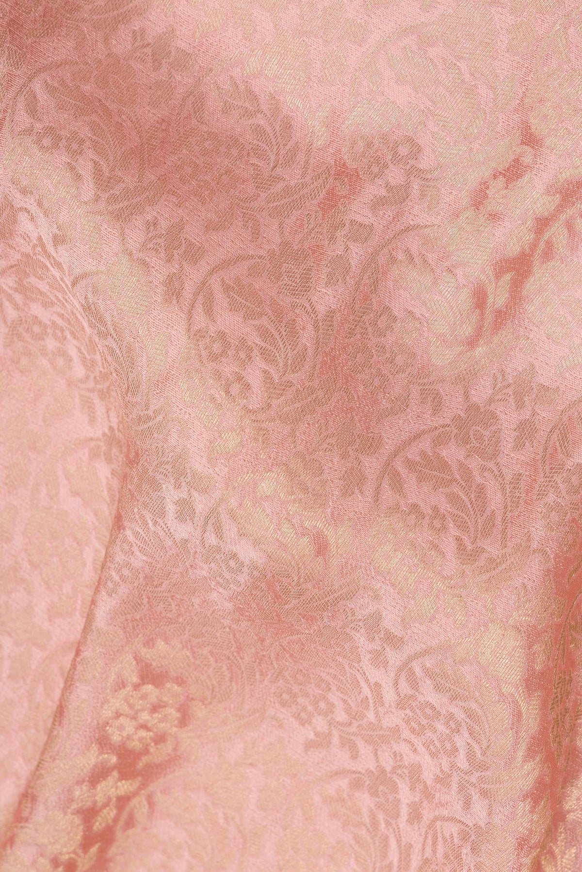 Close up of Peach Dual Tone Crepe Saree with Zari Brocade on the body and Zari Border.  displaying folds