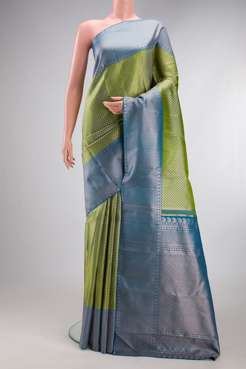 Green Kanchipuram Tissue Silk Saree with Zari Brocade on the body and Zari Border.  displayed on a mannequin