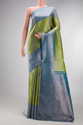 Green Kanchipuram Tissue Silk Saree with Zari Brocade on the body and Zari Border.  displayed on a mannequin