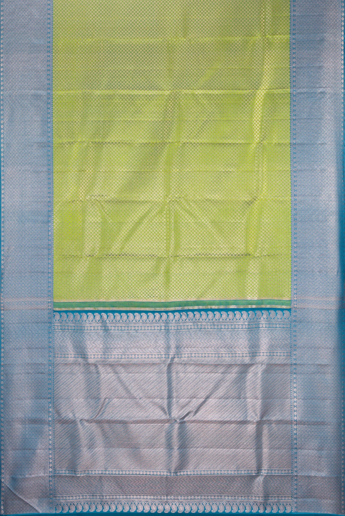 Flat view of Green Kanchipuram Tissue Silk Saree with Zari Brocade on the body and Zari Border. 
