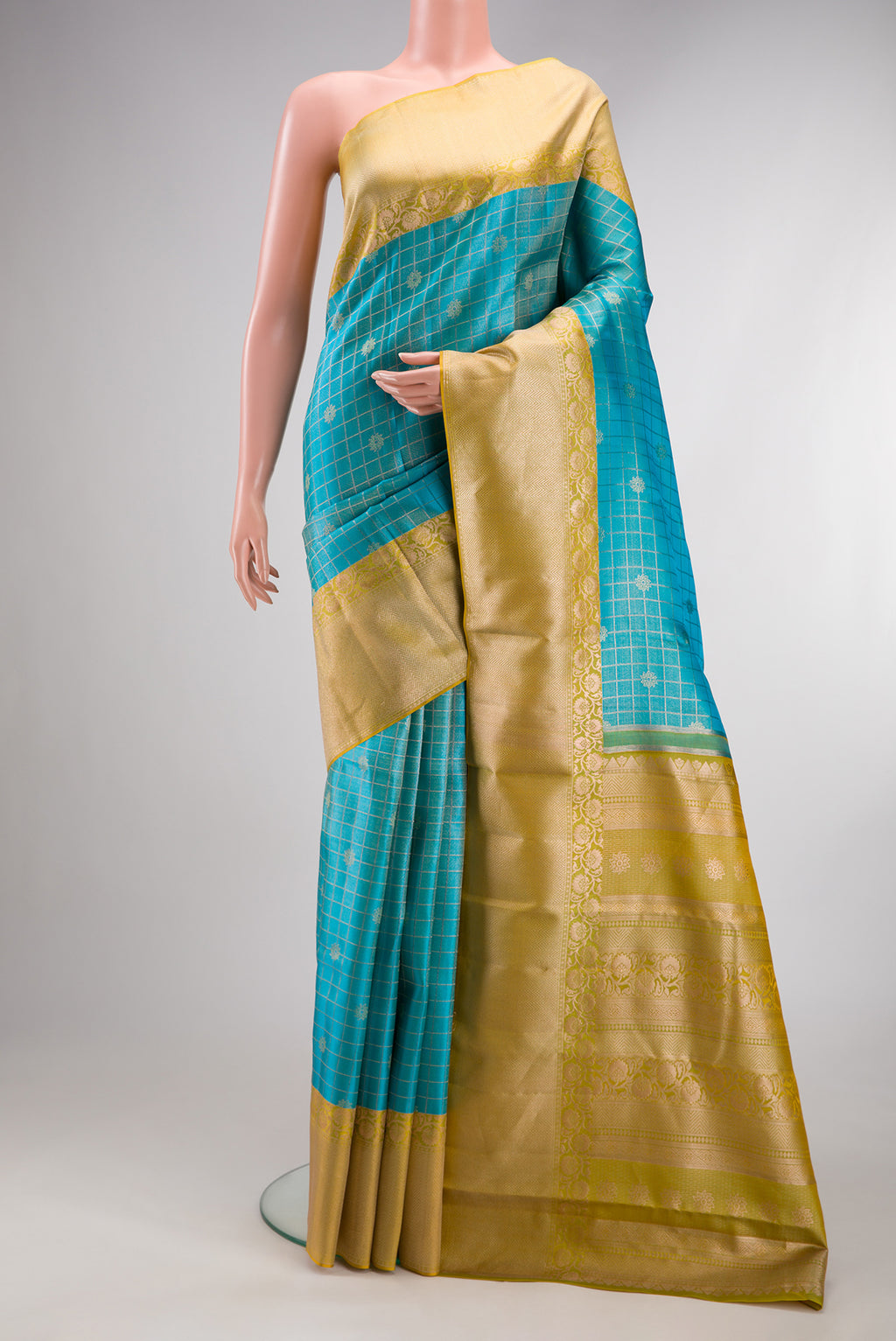 Sky Blue Dual Tone Kanchipuram Tissue Silk Saree with Checked design on the body and Fancy Border.  displayed on a mannequin