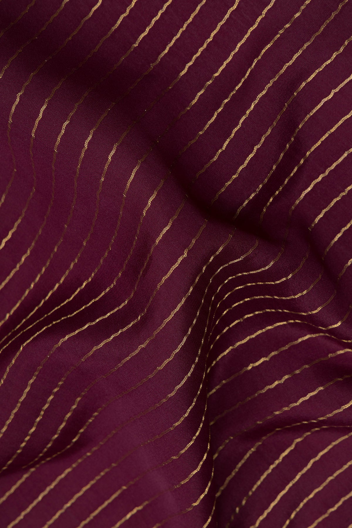 Close up of Coffee Brown Mysore Crepe Saree with Stripes on the body and Embroidered Border.  displaying folds